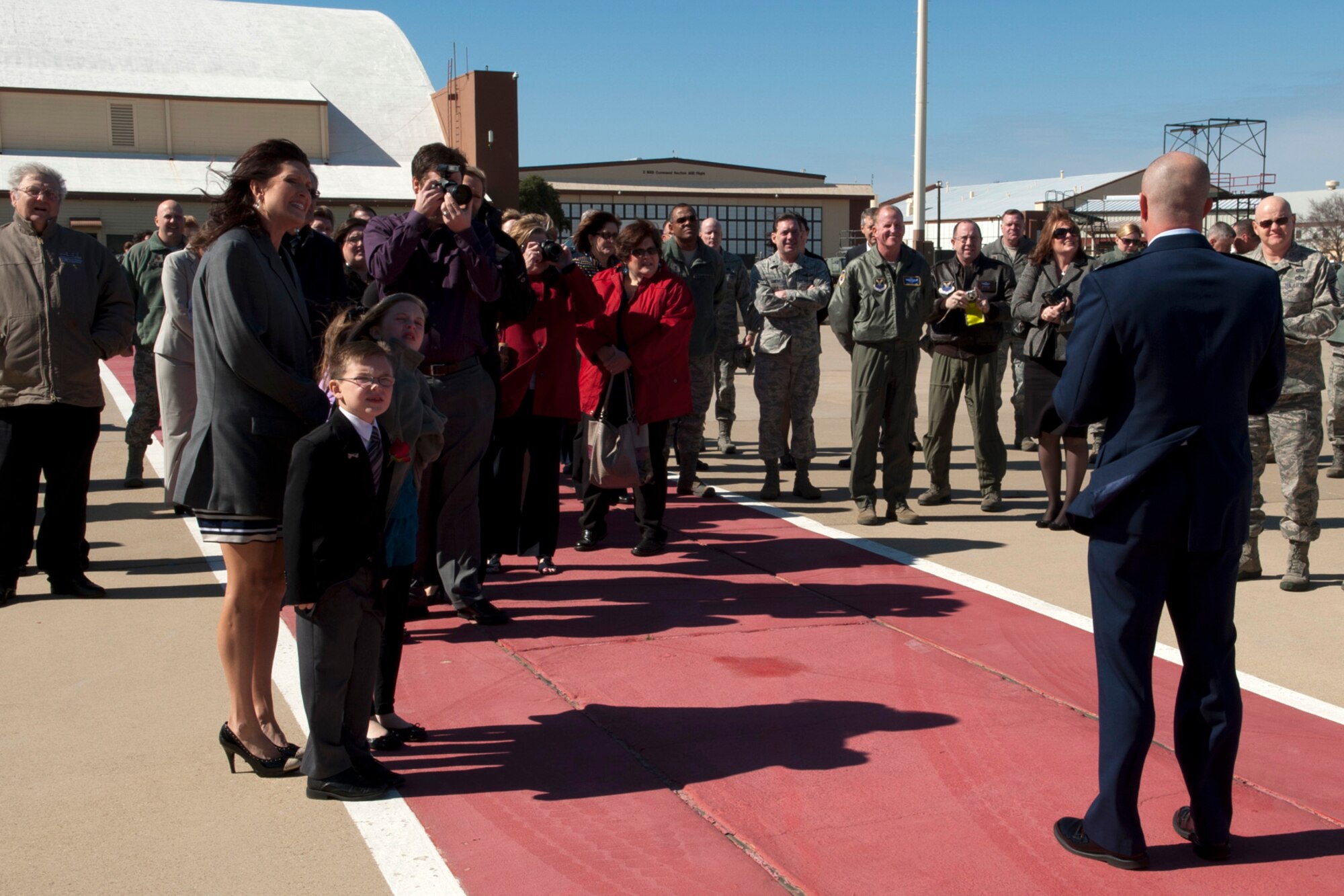 U.S. Air Force Col. Jonathan Ellis, 307th Bomb Wing commander, talks to family, friends and wing personnel, prior to the unveiling of his name on the side of a B-52H Stratofortress following a Change of Command ceremony, Barksdale Air Force Base, La., Feb. 11, 2012. The 307th BW flies the B-52 and has assigned the 93rd and 343rd Bomb Squadrons. (U.S. Air Force photo by Master Sgt. Greg Steele/Released)