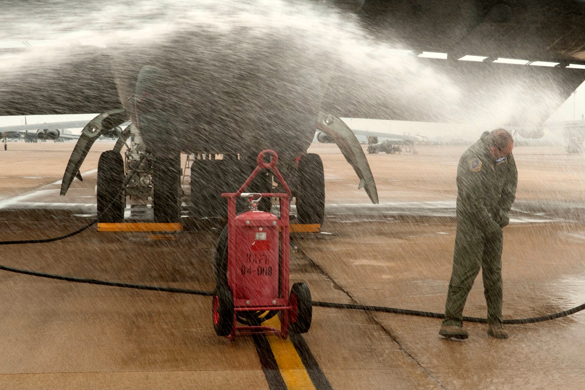 U.S. Air Force Brig. Gen. John Mooney III, 307th Bomb Wing commander, gets hosed down after returning from his last sortie with the 93rd Bomb Squadron, Barksdale Air Force Base, La., Feb. 10, 2012. Mooney relinquished command of the 307th BW on Feb. 11, 2012, and will assume the duties as Inspector General, Air Force Reserve Command, Robins Air Force Base, Ga. (U.S. Air Force photo by Master Sgt. Greg Steele/Released) 