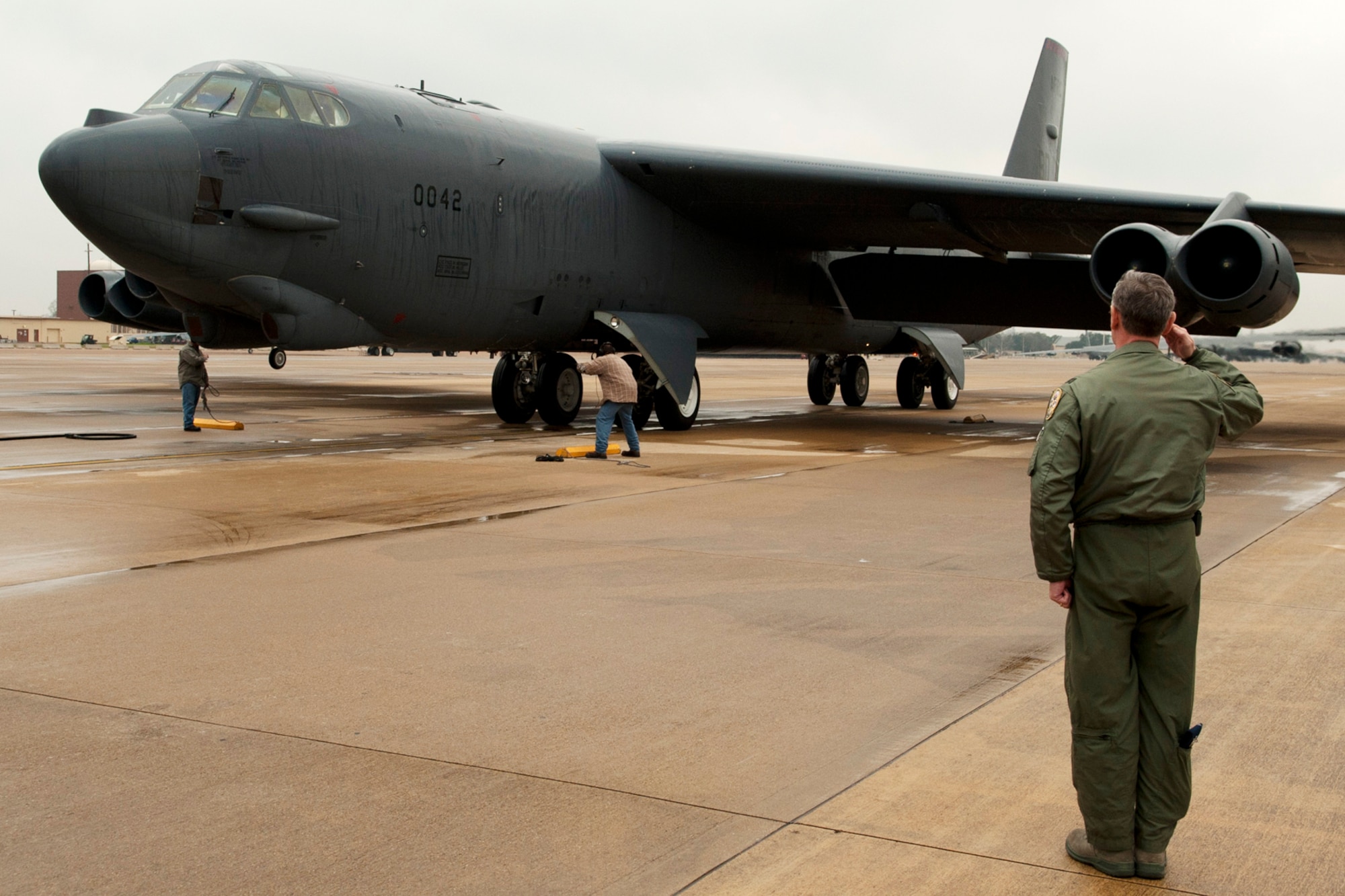 U.S. Air Force Col. Joseph Jones, 307th Bomb Wing vice commander, holds a salute as a 93rd Bomb Squadron B-52H Stratofortress carrying Brig. Gen. John Mooney III, 307th Bomb Wing commander, taxis to its parking spot after returning from a sortie, Barksdale Air Force Base, La., Feb. 10, 2012. This sortie marked the last flight for Mooney before relinquishing command of the 307th BW. (U.S. Air Force photo by Master Sgt. Greg Steele/Released)