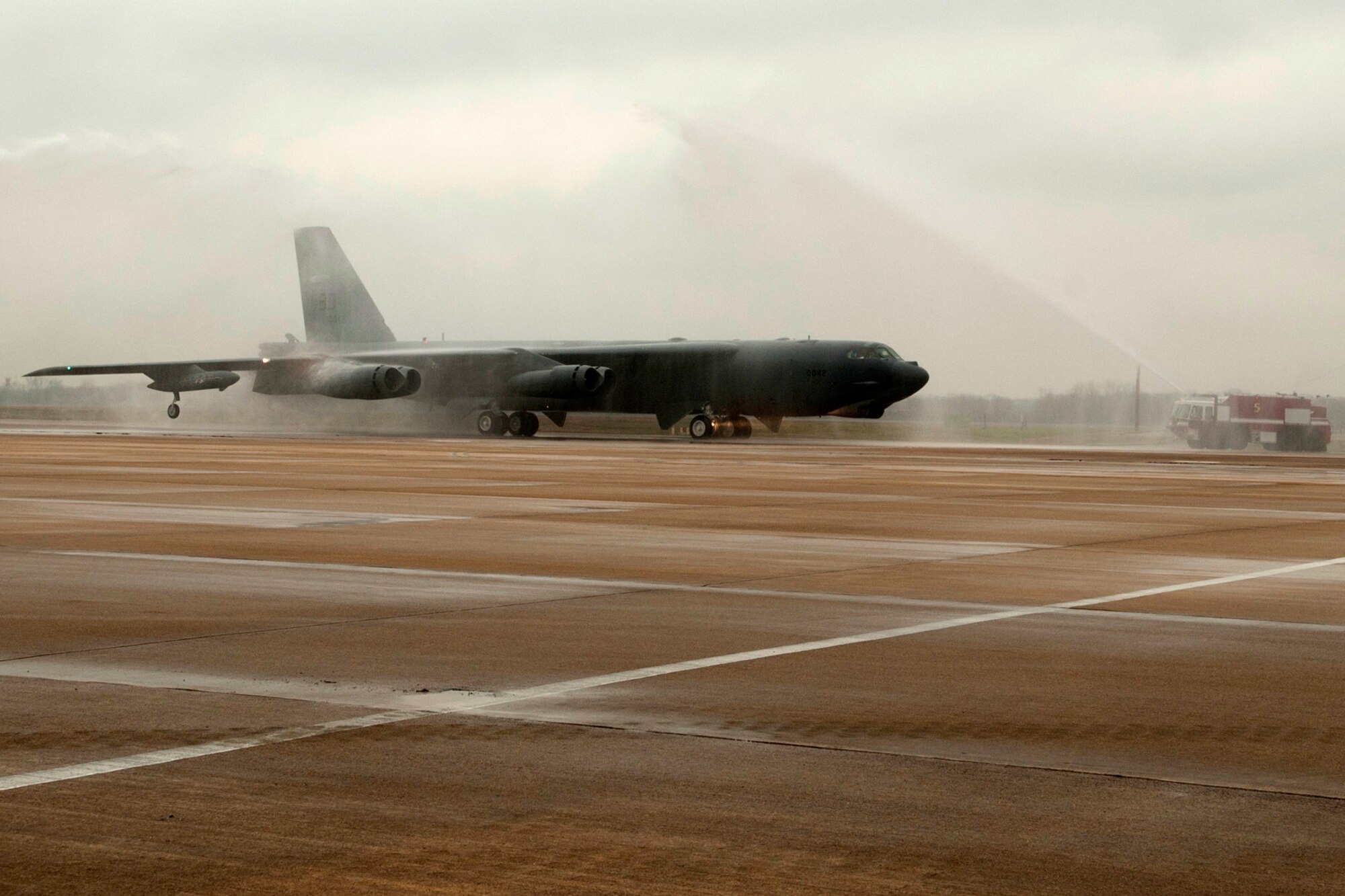 A 93rd Bomb Squadron B-52H Stratofortress carrying Brig. Gen. John Mooney III, 307th Bomb Wing commander, receives a water salute while taxiing to its parking spot after returning from a sortie, Barksdale Air Force Base, La., Feb. 10, 2012. This sortie marked the last flight for Mooney before relinquishing command of the 307th BW. (U.S. Air Force photo by Master Sgt. Greg Steele/Released)
