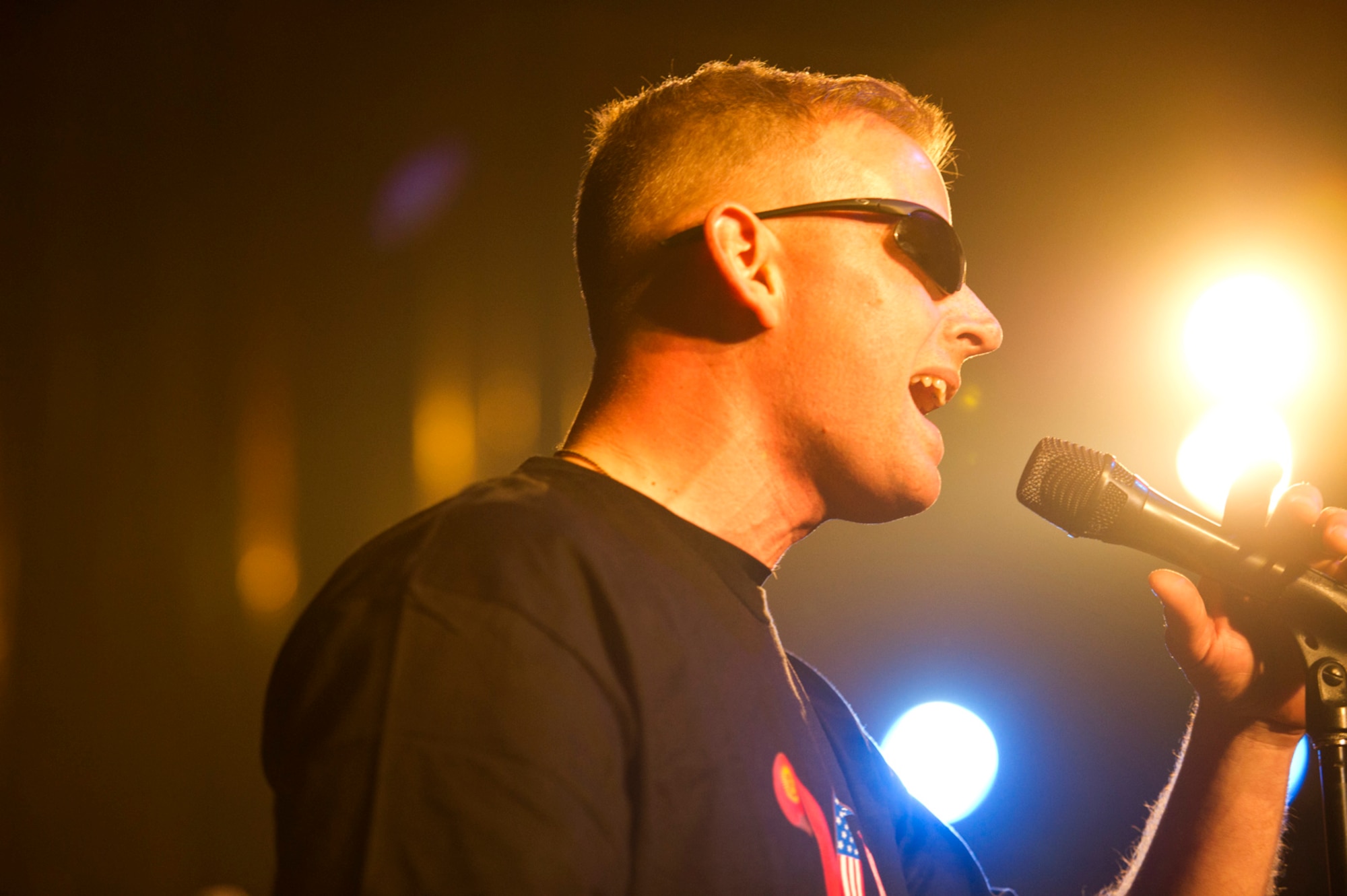 Tech. Sgt. Jeff Saunders, lead sound technician and a vocalist for the U.S. Air Forces Central Band Afterburner, sings during a concert Feb. 7, 2012 at the Bishkek Russian Drama Theater in Kyrgyzstan. The band played to a packed house in celebration of 20 years of friendship between the United States and Kyrgyzstan. (U.S. Air Force photo by Staff Sgt. David Salanitri/Released)

