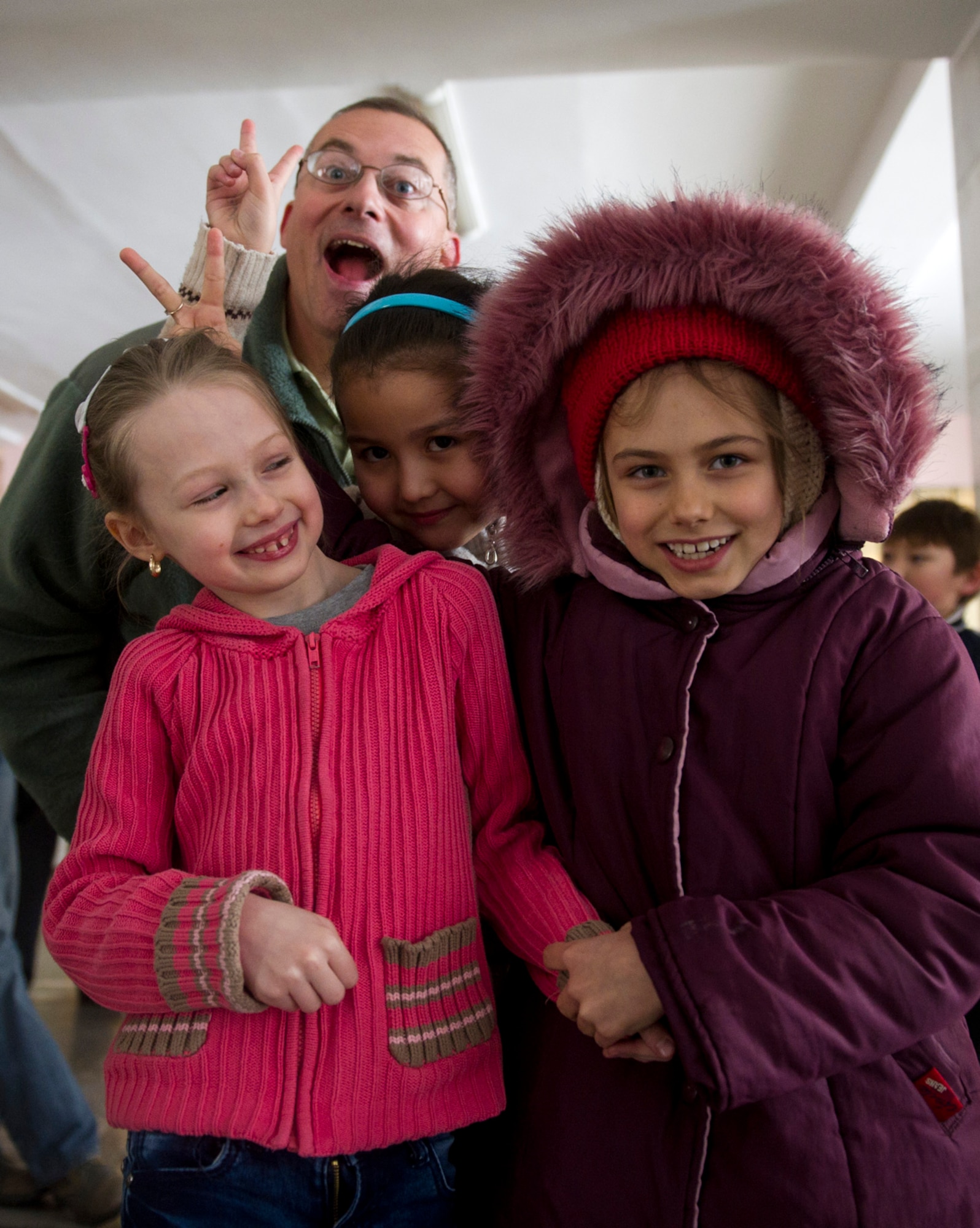 Students from the Bishkek School of Choreography smile and joke with U.S. Air Force Staff Sgt. William Harris, a bandsman with the U.S. Air Forces Central Band Afterburner, after the band performed for their school here in Kyrgyzstan, Feb. 2, 2012.  (U.S. Air Force photo by Staff Sgt. David Salanitri/Released)
