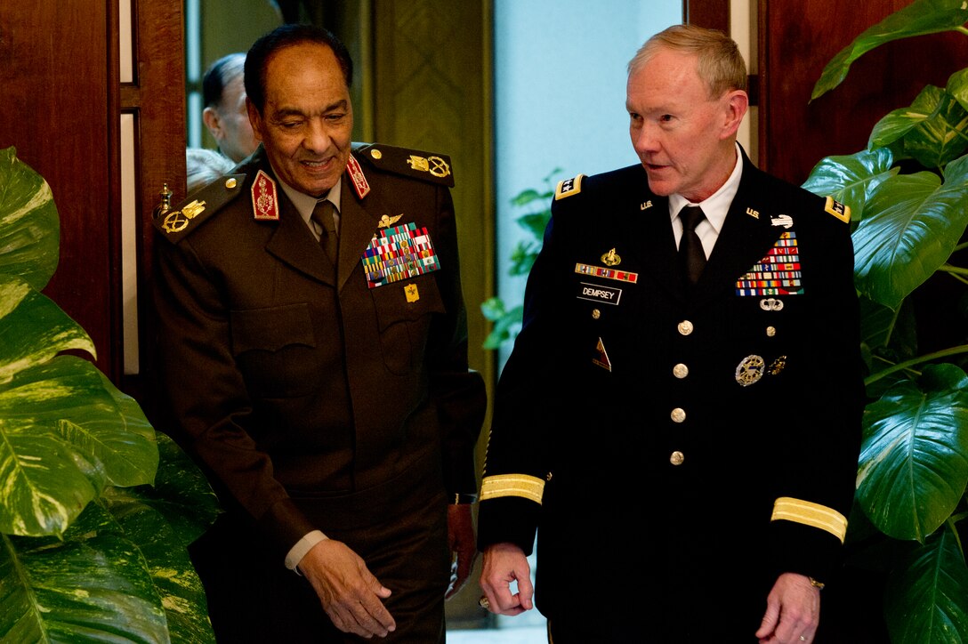 U.S. Army Gen. Martin E. Dempsey, chairman of the Joint Chiefs of Staff, and Egyptian Field Marshal Mohammed Hussein Tantawi walk in the Egyptian Ministry of Defense in Cairo, Egypt, Feb. 11, 2012. 