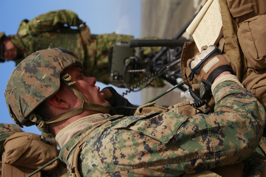 Sgt. Nathan E. Moser, joint fires observer, 1st Air Naval Gunfire Liaison Company writes down a radio transmission during a combined arms exercise with the Japanese Ground Self Defense Force, Feb. 12. The exercise included 81 and 120mm mortars, fixed and rotary wing assets and Naval gun fire.  In addition to the gunfire exercise, the Japanese also practiced calling for fire. Exercise Iron Fist 2012 is a bilateral training exercise that gave the 15th MEU a chance to demonstrate its amphibious capabilities to the Japanese. Moser, 23, is from Chesterfield, Va.