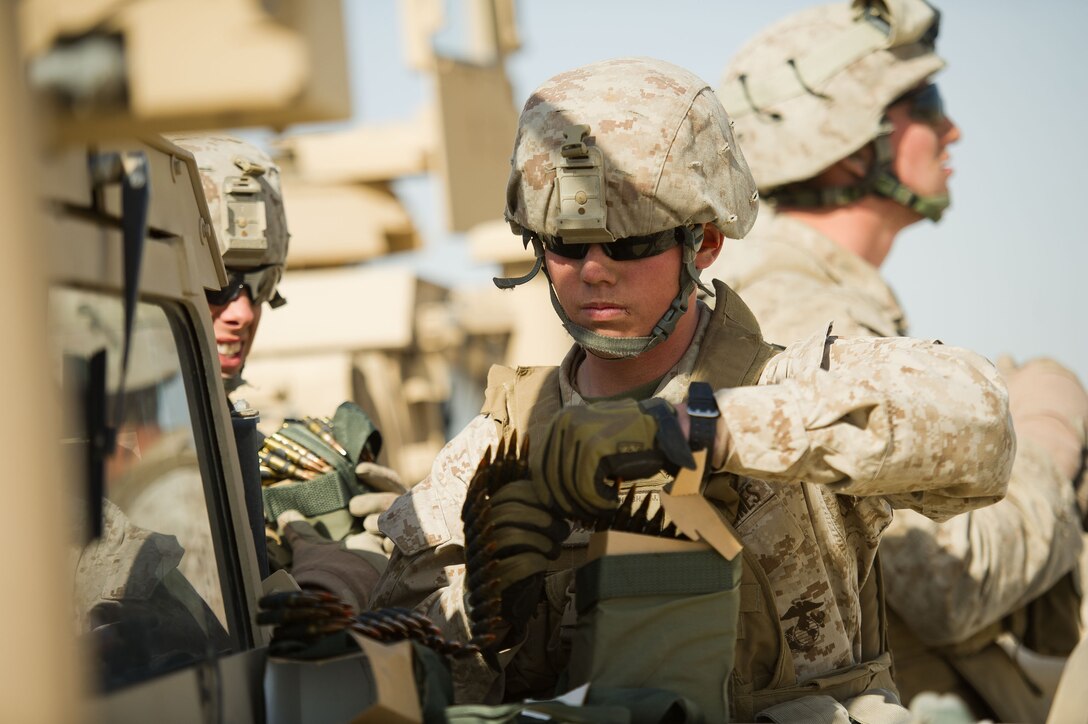 Lance Cpl. Josh J. Haish prepares ammunition before live-fire training here Feb. 12. The 19-year-old Royce City, Texas, native serves as a machine gunner for Battalion Landing Team 3/1, the ground combat element for the 11th Marine Expeditionary Unit. The unit is deployed as part of the Makin Island Amphibious Ready Group, a U.S. Central Command theater reserve force. The group is providing support for maritime security operations and theater security cooperation efforts here.