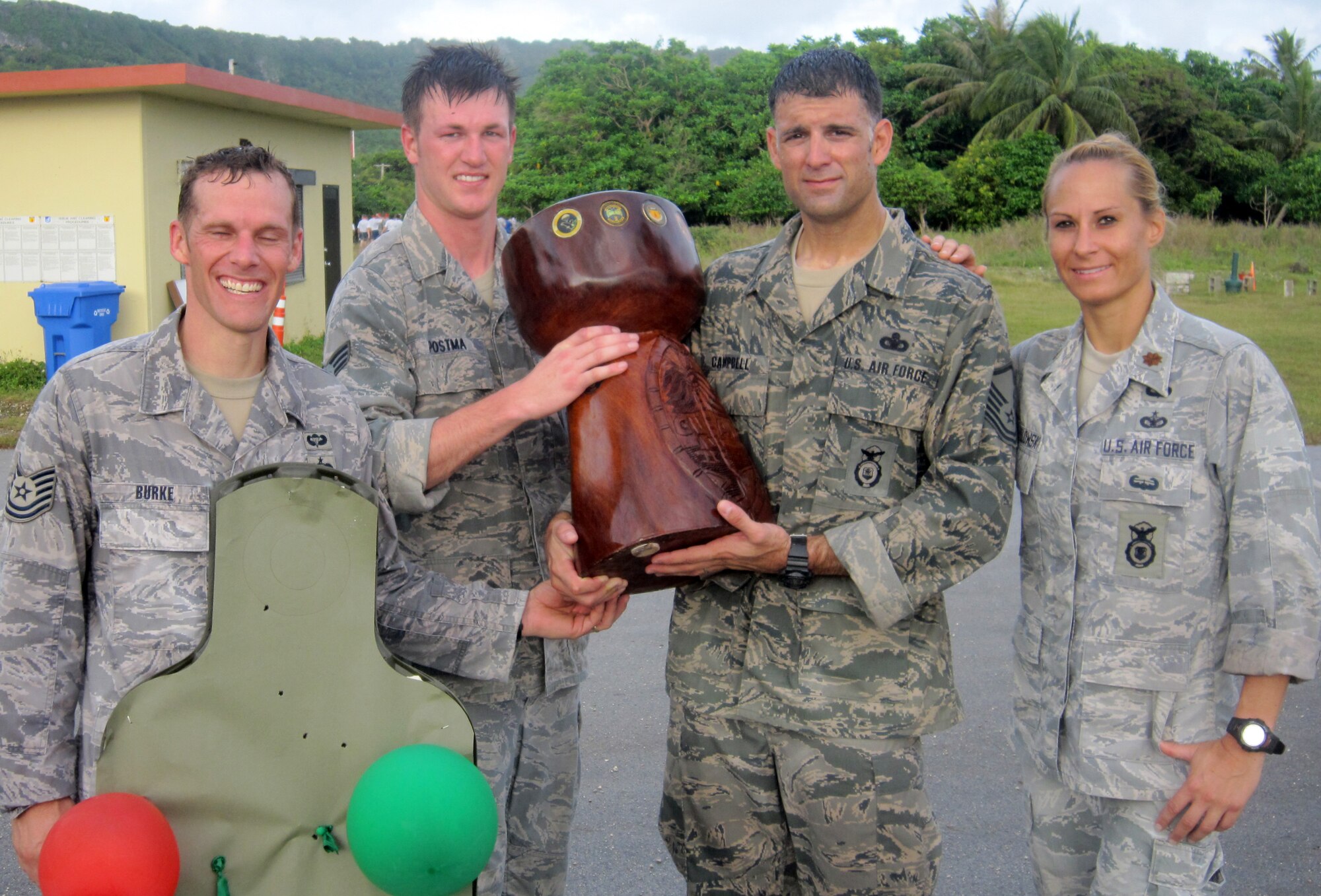 Competitors from the 736th Security Forces Squadron (from left, Tech. Sgt. Vance Burke, Senior Airman Evan Postma, Master Sgt. Seth Campbell and Maj. Tara Opielowski) pose with the coveted latte stone trophy at the combat arms training and maintenance range after claiming victory during the 36th Contingency Response Group's quarterly warrior day competition here Feb. 6. (U.S. Air Force courtesy photo)

