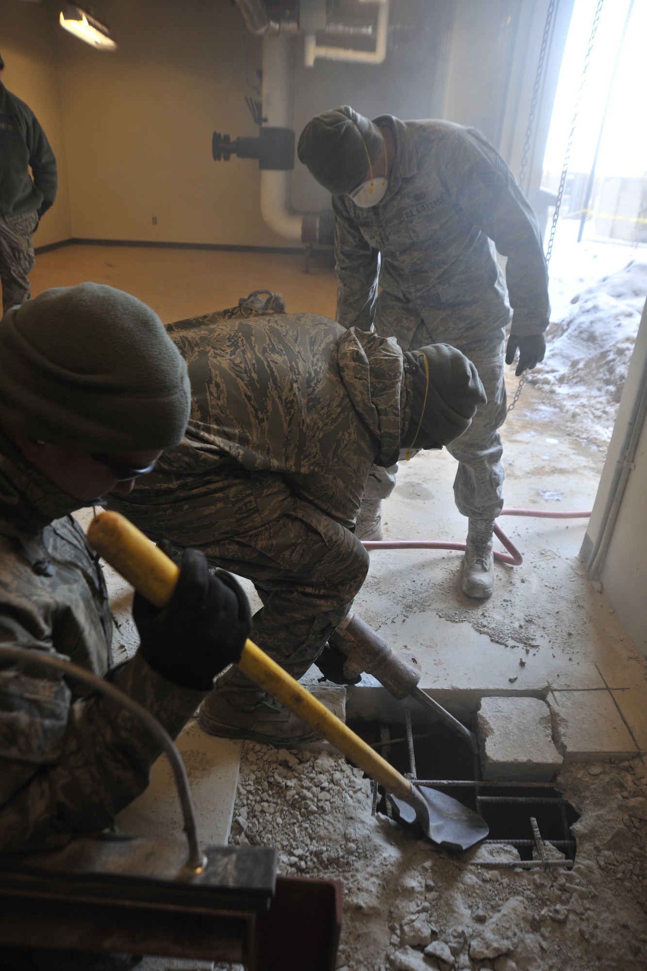 Airmen from the 8th Civil Engineering Squadron pavements and construction equipment flight repair a fire repression system at Kunsan Air Base, Republic of Korea, Feb. 9, 2012. Pavements and construction equipment specialists construct, maintain and inspect concrete and asphalt runways, aircraft parking aprons and roads, support contingency operations by constructing bas facilities and install and maintain drainage structures. (U.S. Air Force photo by Senior Airman Brittany Y. Auld/Released)