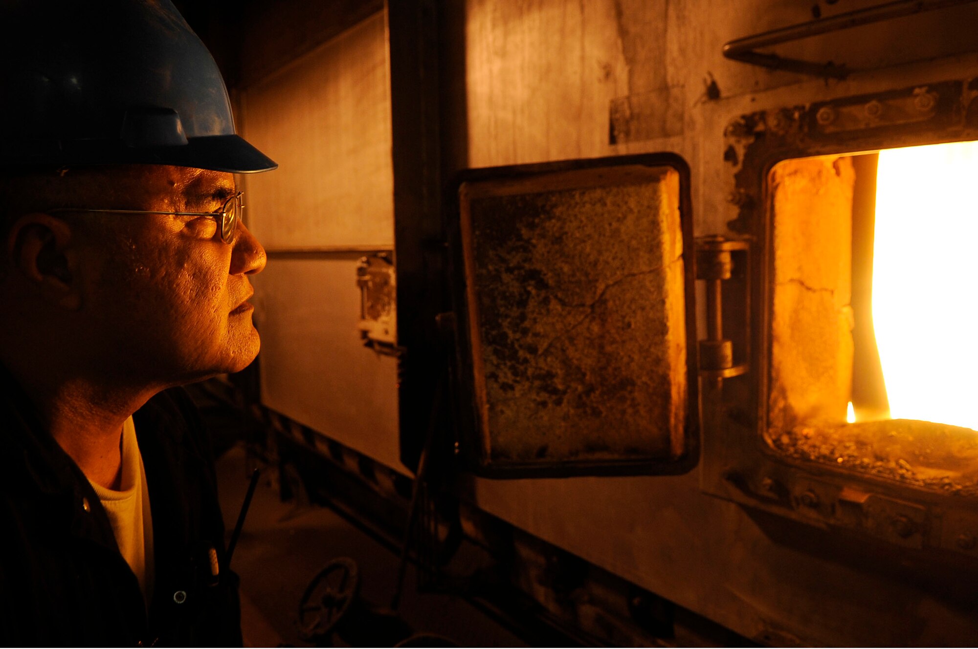 Aumau Aumau, 354th Civil Engineer Squadron fireman, regulates flames at the central heat and power plant Feb. 8, 2012, Eielson Air Force Base, Alaska. Firemen observe and interpret readings on gauges, meters and charts to ensure the boilers are operating properly. (U.S. Air Force photo/Staff Sgt. Jim Araos)