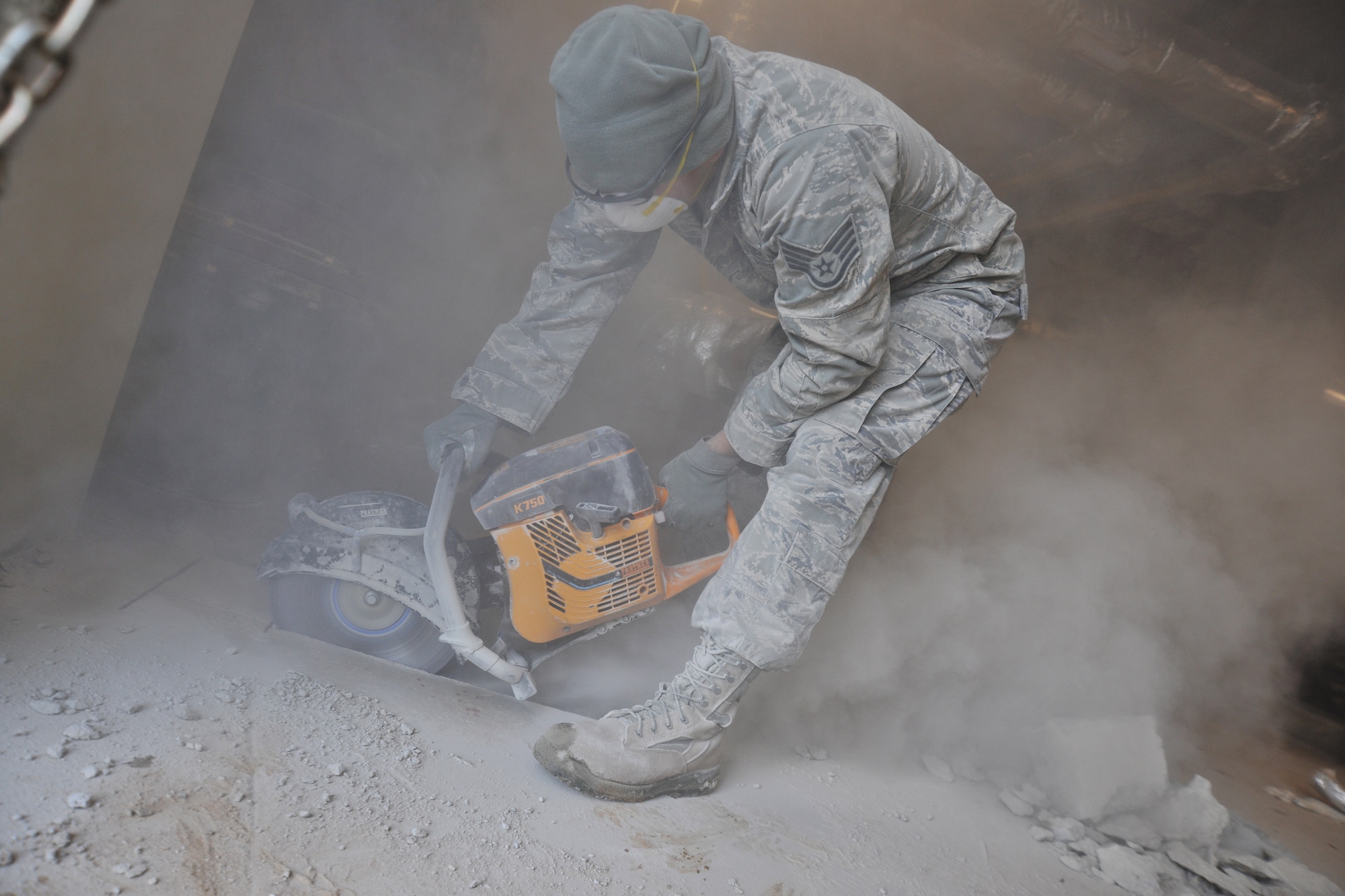 Staff Sgt. Walter Hernanadez  8th Civil Engineering Squadron pavements and construction equipment, uses an electric saw to remove concrete during a fire repression system repair, Feb. 9, 2012 at Kunsan Air Base, Republic of Korea. Pavements and construction equipment specialists construct, maintain and inspect concrete and asphalt runways, aircraft parking aprons and roads, support contingency operations by constructing bas facilities and install and maintain drainage structures.  (U.S. Air Force photo by Senior Airman Brittany Y. Auld/Released)