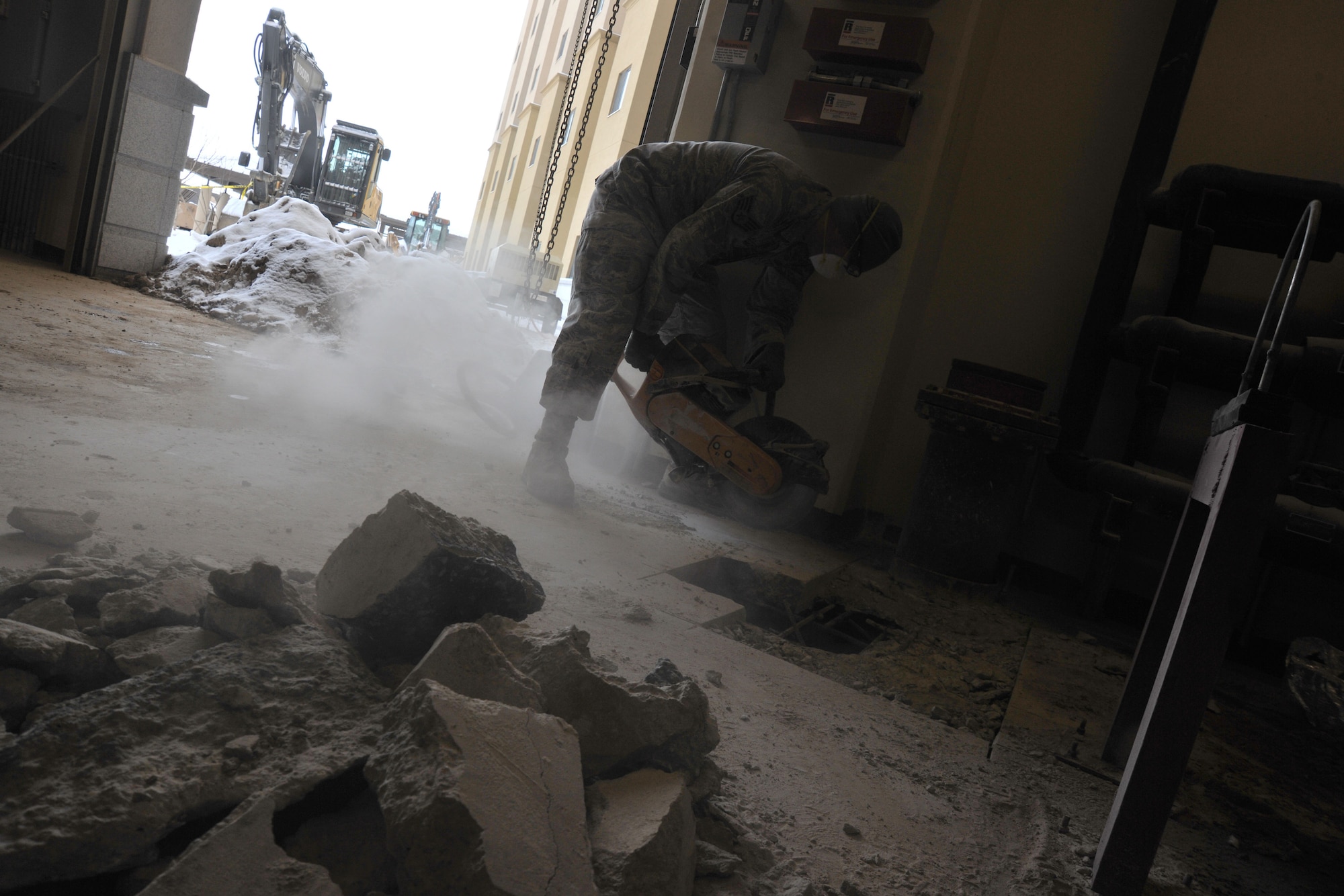 Staff Sgt. Walter Hernanadez  8th Civil Engineering Squadron pavements and construction equipment, uses an electric saw to remove concrete during a fire repression system repair, Feb. 9, 2012 at Kunsan Air Base, Republic of Korea. Pavements and construction equipment specialists construct, maintain and inspect concrete and asphalt runways, aircraft parking aprons and roads, support contingency operations by constructing bas facilities and install and maintain drainage structures.  (U.S. Air Force photo by Senior Airman Brittany Y. Auld/Released)