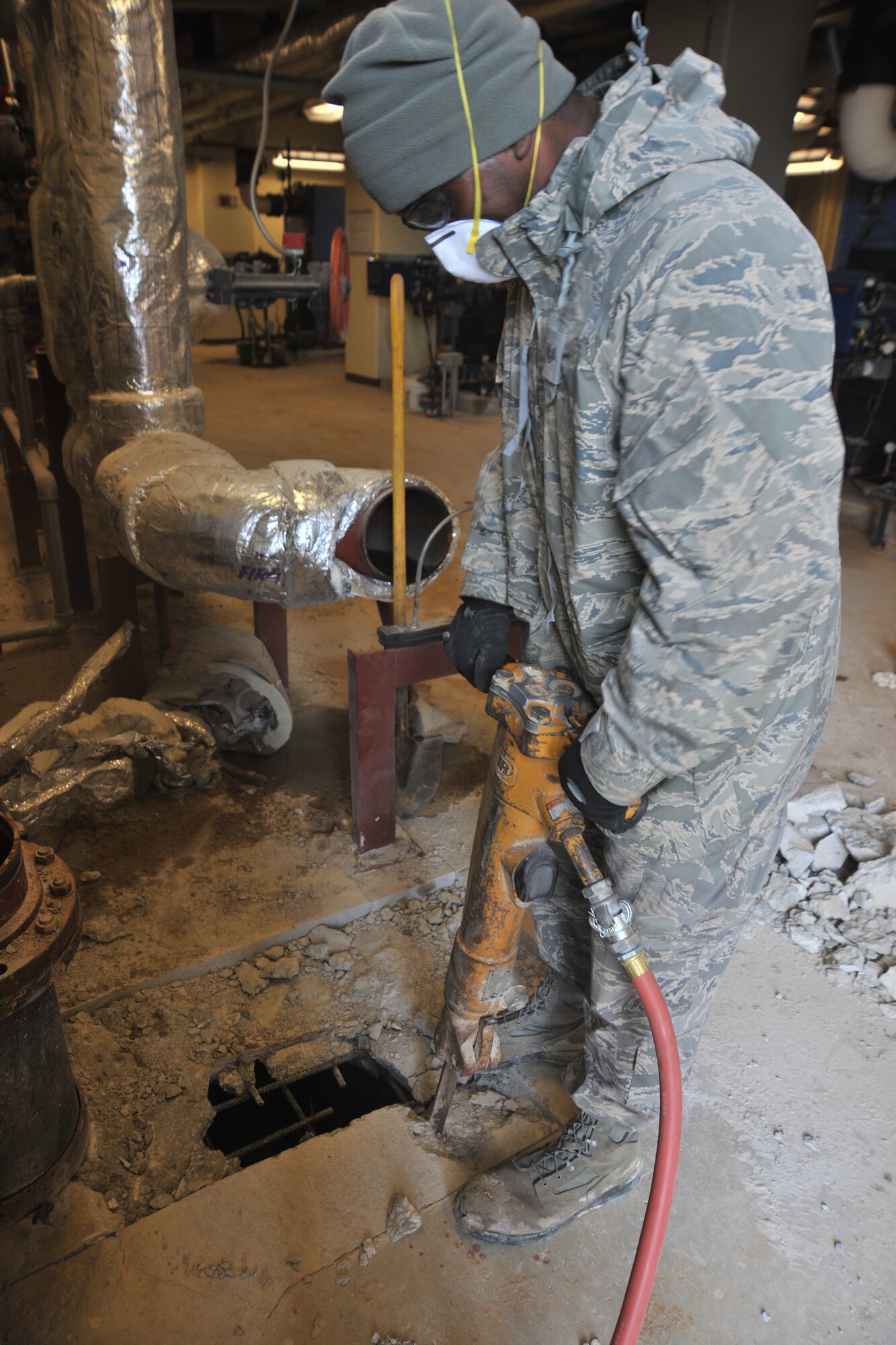 Staff Sgt. Mardie Wilson, 8th Civil Engineering Squadron pavements and construction equipment, uses a jack hammer to shatter concrete during a fire repression system repair, Feb. 9, 2012 at Kunsan Air Base, Republic of Korea. Pavements and construction equipment specialists construct, maintain and inspect concrete and asphalt runways, aircraft parking aprons and roads, support contingency operations by constructing bas facilities and install and maintain drainage structures.  (U.S. Air Force photo by Senior Airman Brittany Y. Auld/Released) 
