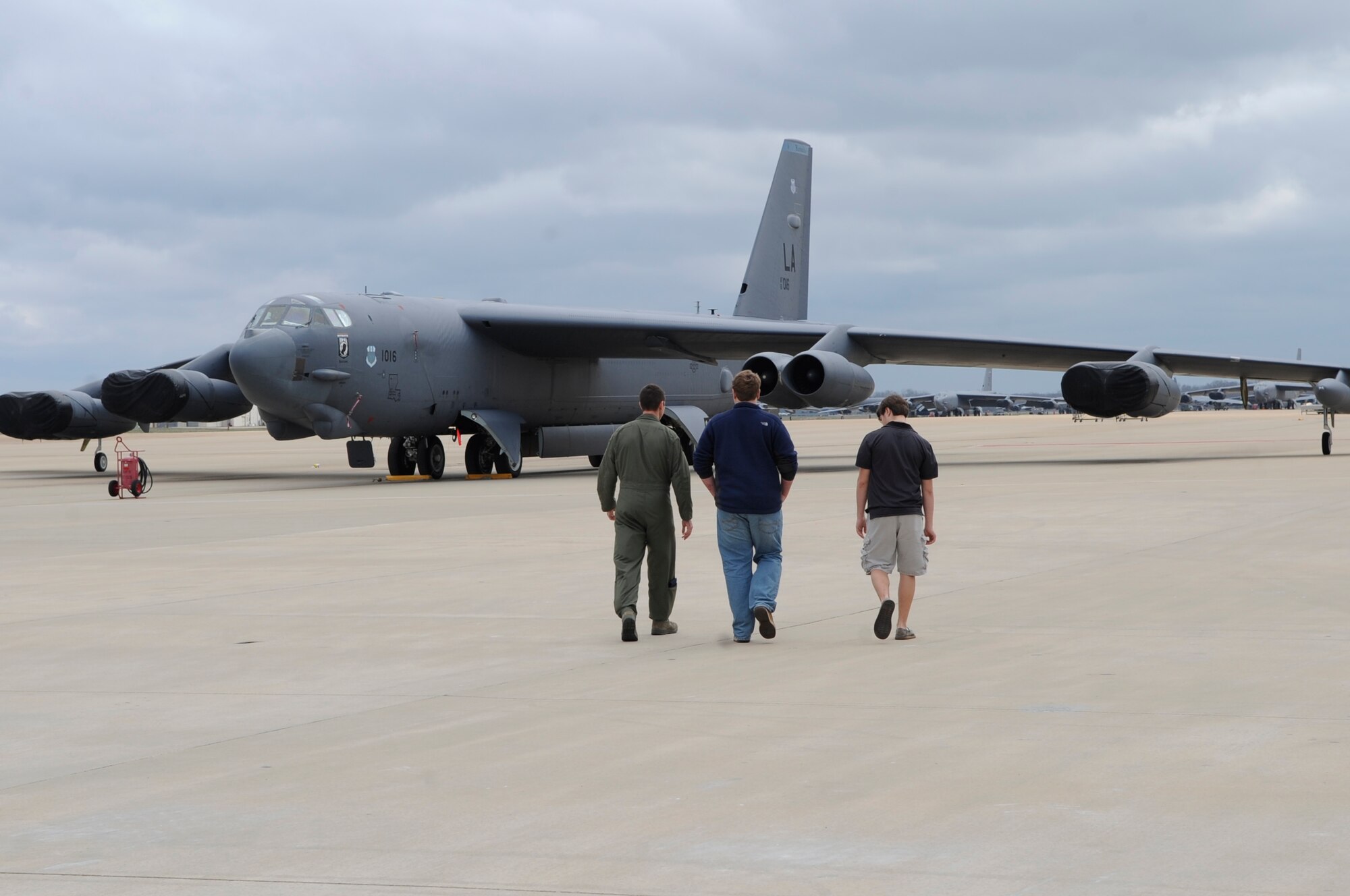 Maj. Ken Cates, 11th Bomb Squadron pilot, walks with Lane Williams and Nathan Naranjo, Greenacres Middle School students, toward a B-52H Stratofortress on the flightline at Barksdale Air Force Base, La., Feb. 2. The students came to Barksdale as part of their job-shadowing day program. They learned all about the education and training requirements needed to become a pilot in the Air Force. (U.S. Air Force photo/Airman 1st Class Andrea F. Liechti)(RELEASED)