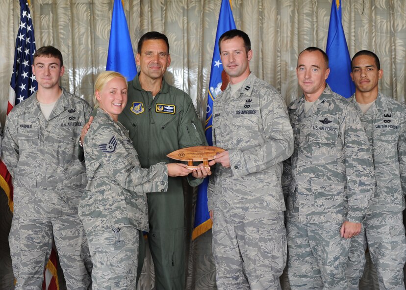 Lt. Gen. Ted Kresge, 13th Air Force Commander presents members of the 647th Expeditionary Civil Engineer Squadron's Explosive Ordnance Disposal team, with an award at the Hickam Officer's Club on Joint Base Pearl Harbor-Hickam, February 10.