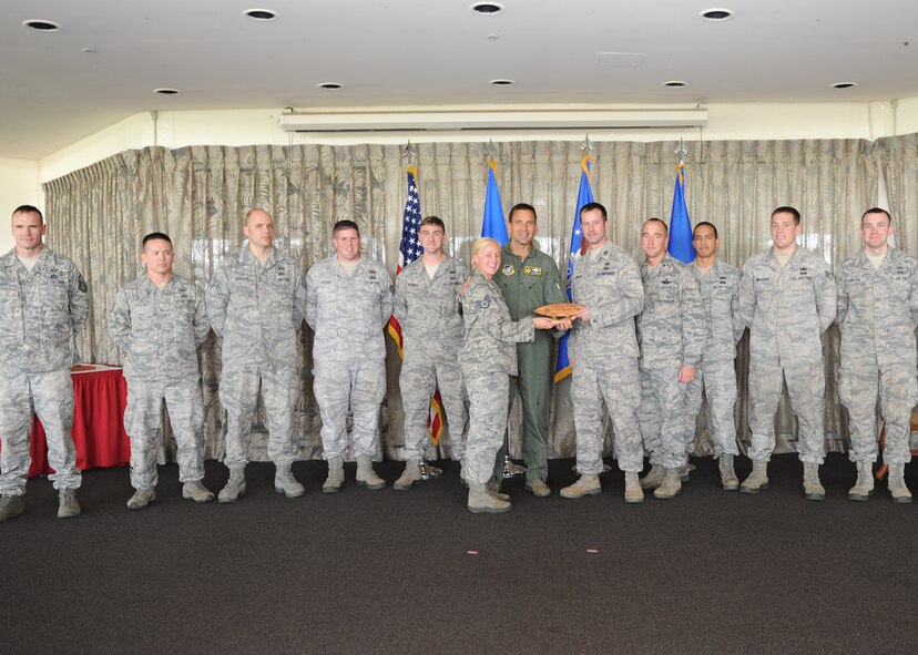Lt. Gen. Ted Kresge, 13th Air Force Commander presents members of the 647th Expeditionary Civil Engineer Squadron's Explosive Ordnance Disposal team, with an award at the Hickam Officer's Club on Joint Base Pearl Harbor-Hickam, February 10.