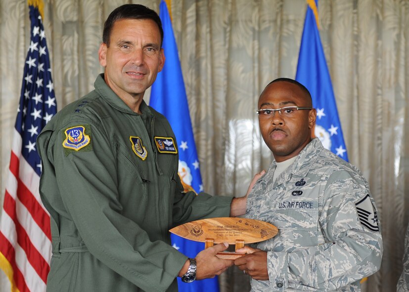 Lt. Gen. Ted Kresge, 13th Air Force Commander presents Master Sgt Alfred Wells, a 13th Air Force team member, with an award at the Hickam Officer's Club on Joint Base Pearl Harbor-Hickam, February 10.