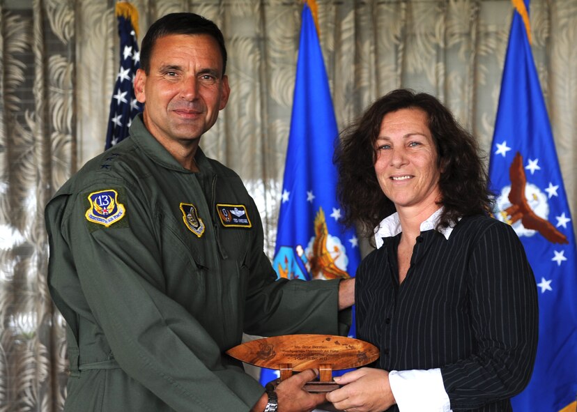 Lt. Gen. Ted Kresge, 13th Air Force Commander presents Ilene Berman, a 13th Air Force team member, with an award at the Hickam Officer's Club on Joint Base Pearl Harbor-Hickam, February 10.