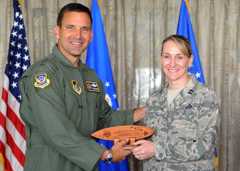 Lt. Gen. Ted Kresge, 13th Air Force Commander presentsCapt Janel Uiterwyk, a 13th Air Force team member, with an award at the Hickam Officer's Club on Joint Base Pearl Harbor-Hickam, February 10.
