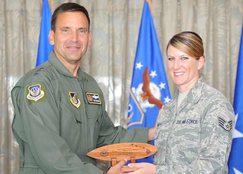 Lt. Gen. Ted Kresge, 13th Air Force Commander presents Staff Sgt Amy Stacey, a 13th Air Force team member, with an award at the Hickam Officer's Club on Joint Base Pearl Harbor-Hickam, February 10.