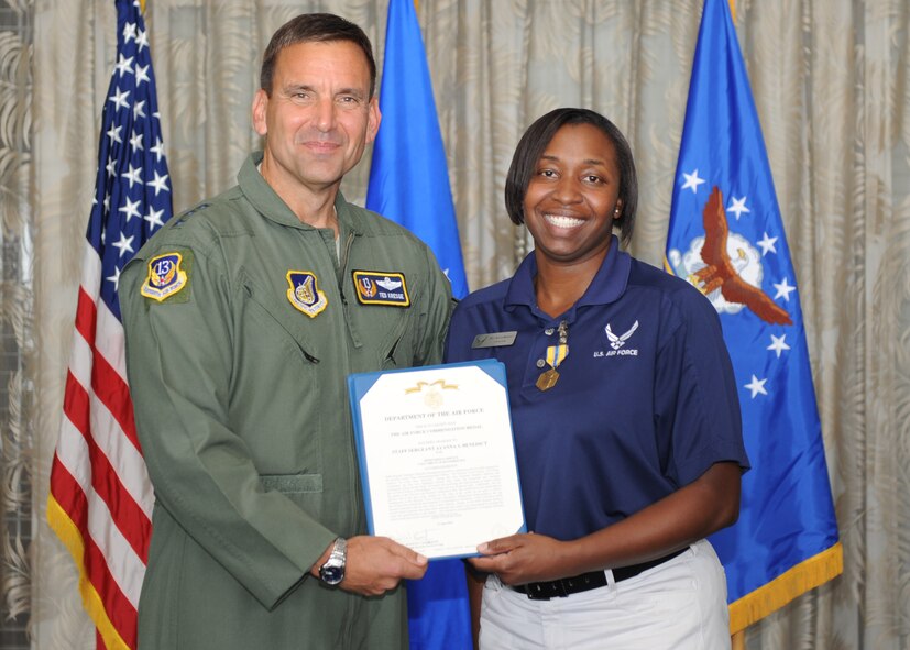 Lt. Gen. Ted Kresge, 13th Air Force Commander presents Staff Sgt Ayanna Benedict, a 13th Air Force team member, with a medal and citation at the Hickam Officer's Club on Joint Base Pearl Harbor-Hickam, February 10.