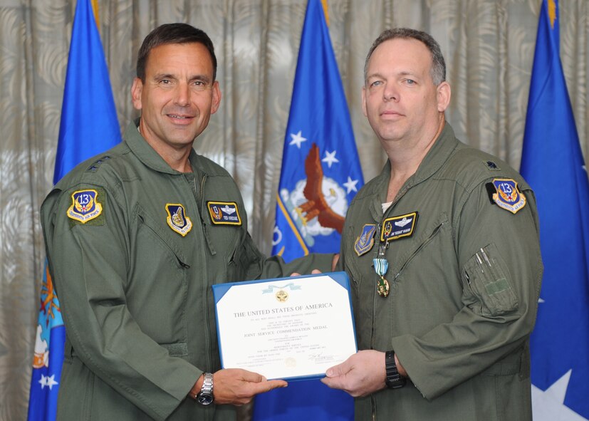 Lt. Gen. Ted Kresge, 13th Air Force Commander presents Lt Col James McGann, a 13th Air Force team member, with a medal and citation at the Hickam Officer's Club on Joint Base Pearl Harbor-Hickam, February 10.