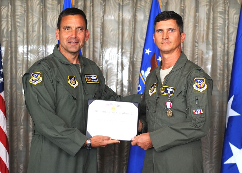 Lt. Gen. Ted Kresge, 13th Air Force Commander presents Col Charles Olson, a 13th Air Force team member, with a medal and citation at the Hickam Officer's Club on Joint Base Pearl Harbor-Hickam, February 10.