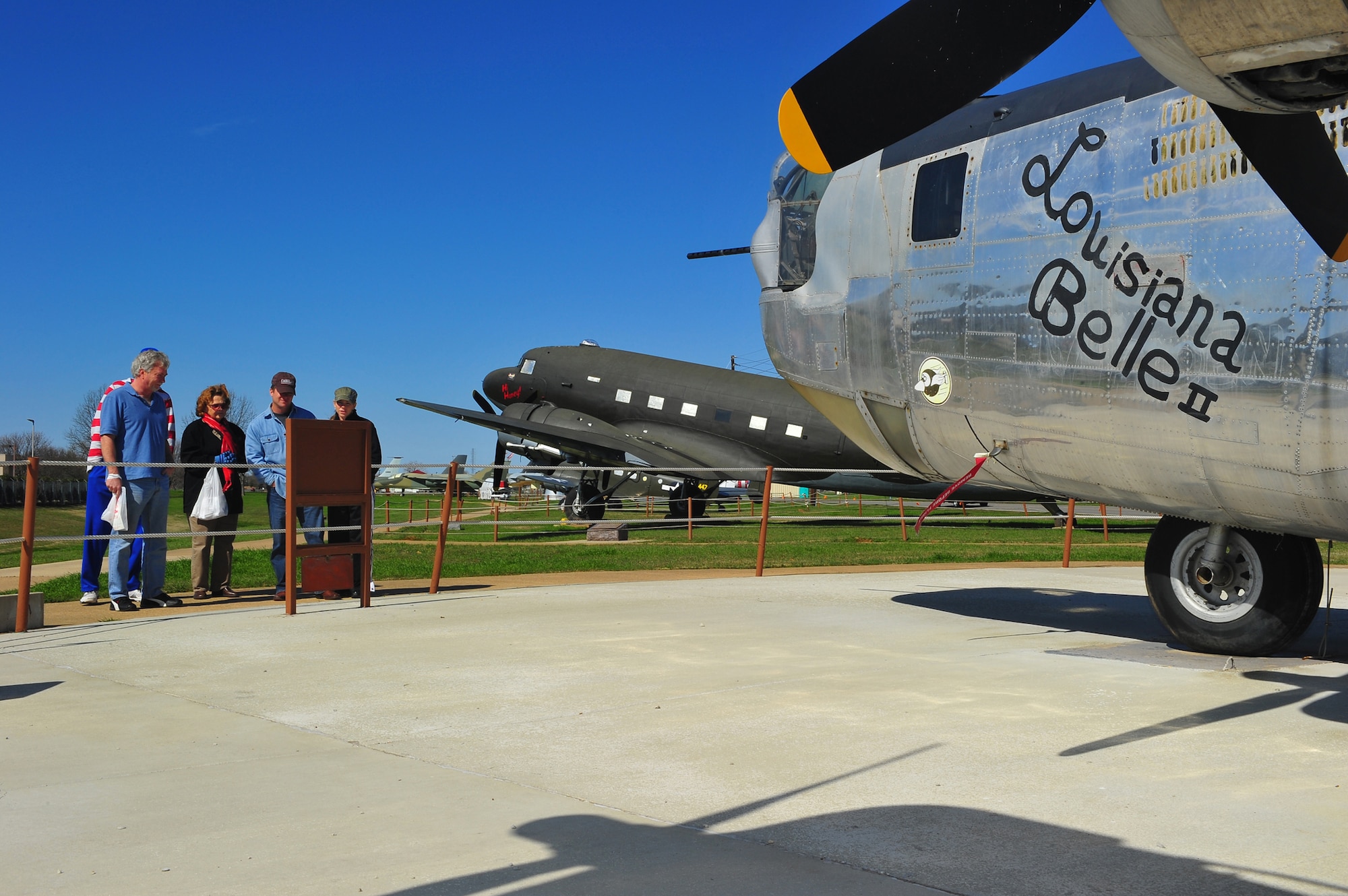 Visitors to the 8th Air Force Museum read about the B-24 Liberator, Louisiana Belle II, at the museum?s air park Feb. 12, at Barksdale Air Force Base, La. The aircraft is one of only 17 of the B-24 series of bombers currently on display or in the restoration process worldwide. The original production amounted to more than 18,000 bombers. (U.S. Air Force photo/Tech. Sgt. Mike Andriacco)(Released)