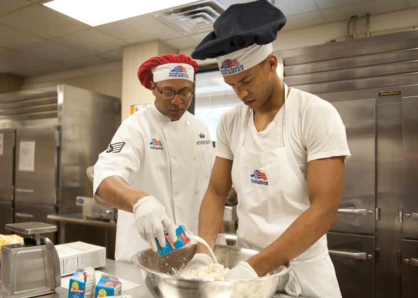 U.S. Air Force Staff Sgt. Tony Witherspoon and Airman 1st Class Dominique Castillo, both from the 23d Force Support Squadron, prepare for lunch during an inspection for the John L. Hennessy award at the Georgia Pines Dining Facility, Feb. 10, 2012, at Moody Air Force Base, Ga. The 23d FSS recently won the Air Combat Command Hennessy award and are now competing to win for the Air Force Level.  (U.S. Air Force photo by Senior Airman Eileen Meier/Released)