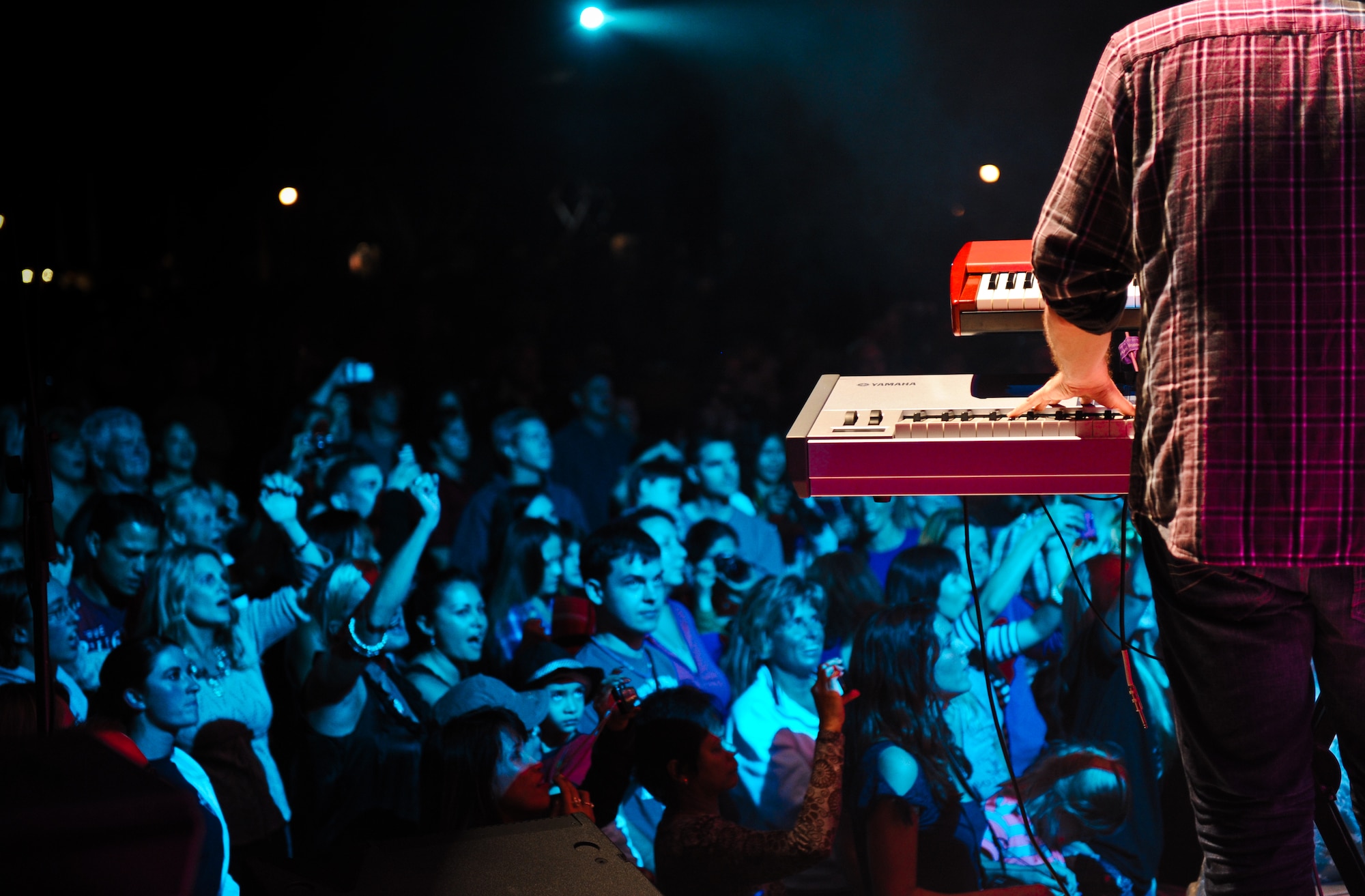 Ben Lewis, a keyboardist with the Lt. Dan Band, performs a concert for the troops Feb. 10 at Joint Base Pearl Harbor-Hickam, Hawaii Feb. 10. The band closed the show with "Proud to be an American." The crowd sang along and held up lighters throughout the song. (U.S. Air Force photo/Senior Airman Lauren Main)