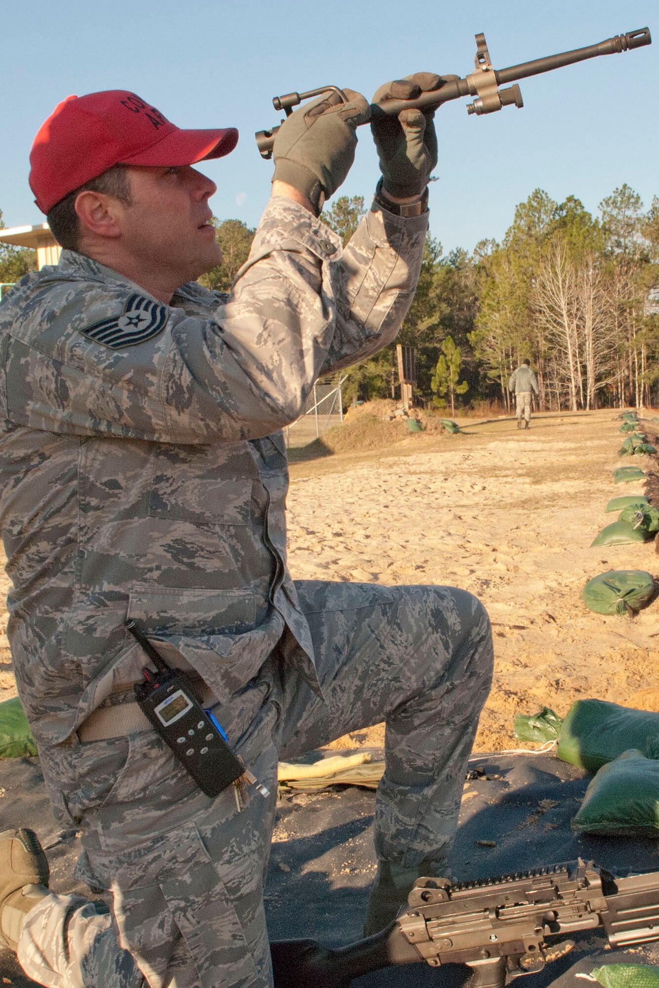 Tech. Sgt. Brian Tyler, 307th Security Forces Squadron craftsman, checks the barrel of a M249 machine gun Feb. 11, 2011 at Ft. Polk, La.  Tyler served as range cadre for weapons training on the range.  The barrel check was one of many safety checks required throughout the day.  (U.S. Air Force photo by Staff Sgt. Ted Daigle/Released) 