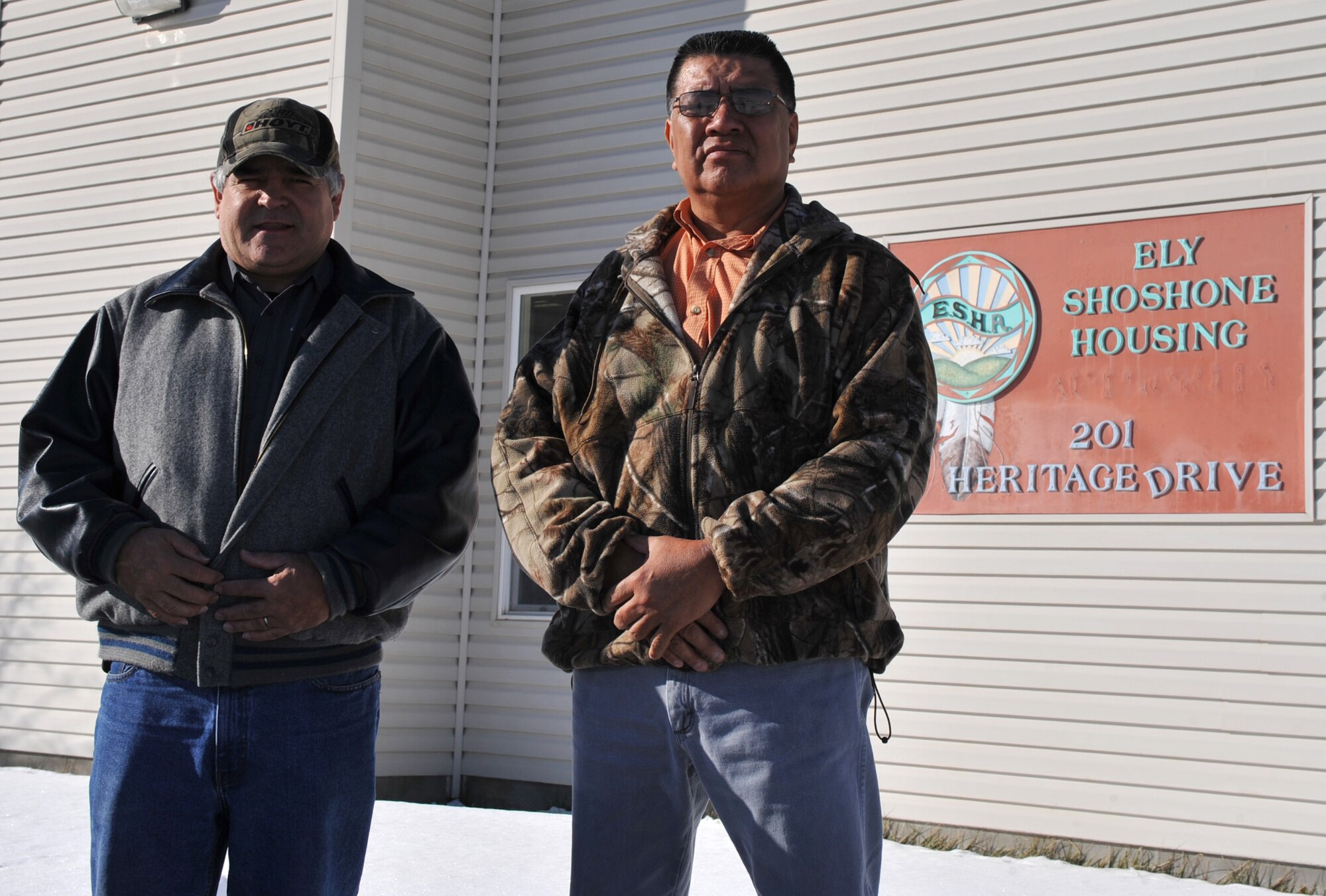 Alvin Marques, Ely Shoshone Housing Department maintenance supervisor, and Wesley Allison, Ely Shoshone Housing Department Executive Director, stand in front of the Ely Shoshone housing office, Jan. 24, 2012, in Ely, Nevada. Mountain Home Air Force Base teamed up with Operation Walking Shield to donate eight houses to the Ely Shoshone Tribe to help reduce overcrowding and homelessness issues the American Indian reservations are facing. (U.S. photo by Airman 1st Class Heather Hayward/Released)