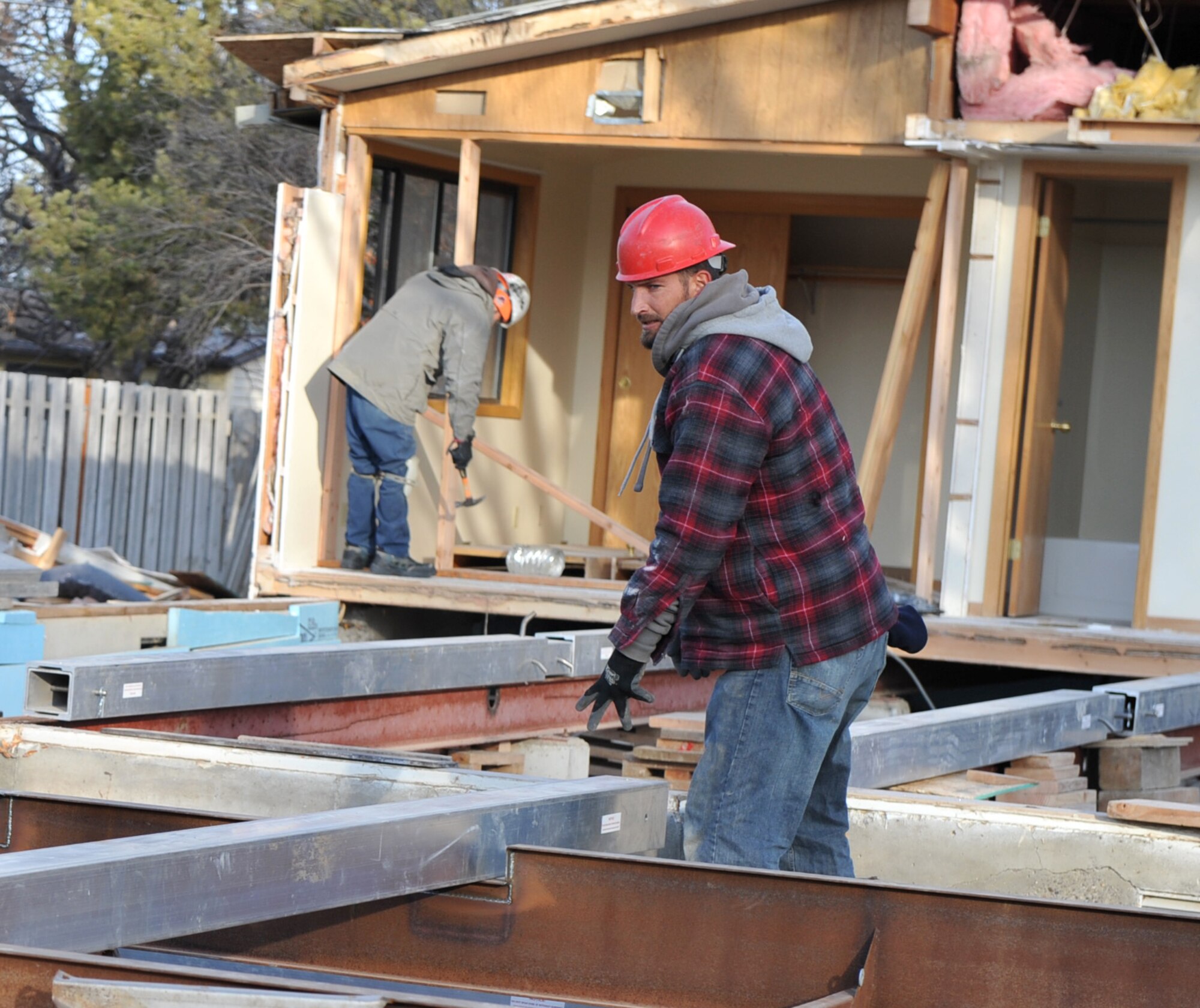 Jason Huett, a construction worker with U.S. Modular Group Inc, disassembles a house into sections before loading it onto a flatbed trailer Dec. 15, 2011, at Mountain Home Air Force Base, Idaho. The homes are being donated by the base to the Ely Shoshone Tribe in Ely, Nev. in collaboration with Operation Walking Shield. (U.S. Air Force photo by Airman 1st Class Heather Hayward/Released)