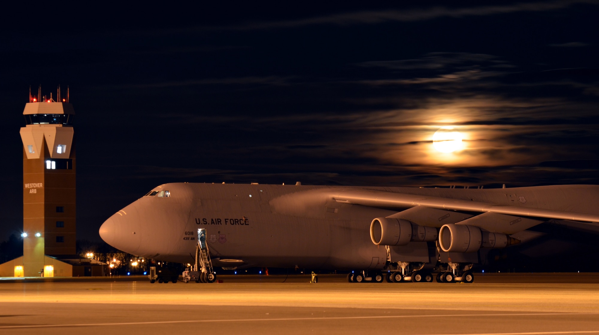 The moon creeps over Westovers C-5s on a chilly January evening, illuminating everything below it. Westover remains viable under restructuring proposals and is the only Air Force Reserve Base to house a Reginal Isochronal dock. (U.S. Air Force photo/SrA. Kelly Galloway)