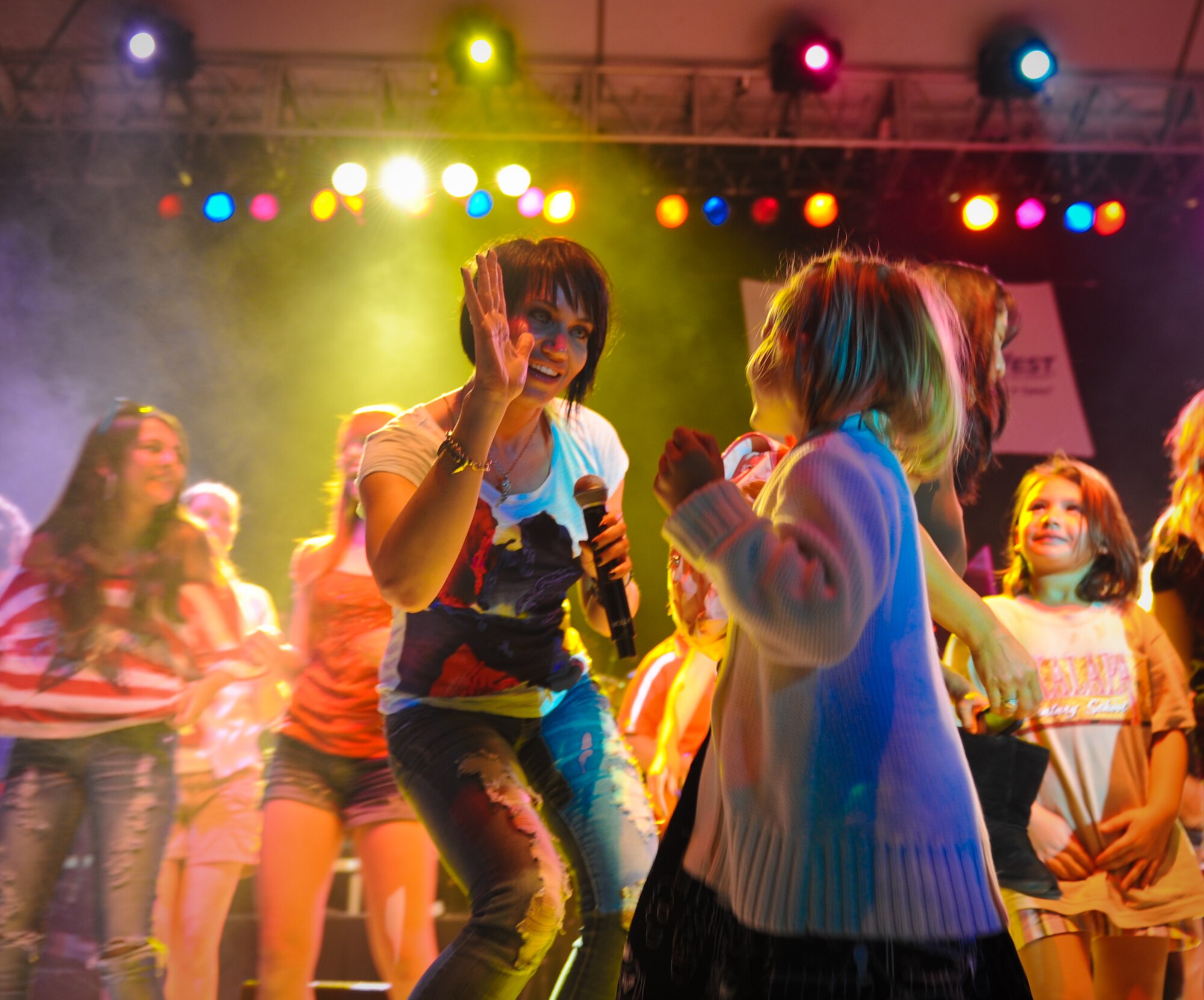 Molly Callinan, a vocalist with the Lt. Dan Band, high-fives a young fan as she makes her way on stage during the Lt, Dan Band concert Feb. 10 at Joint Base Pearl Harbor-Hickam, Hawaii. The Lt. Dan Band was formed in early 2003 and by 2004 they were on tour performing for troops. Their first concerts were overseas on a United Services Organizations, Inc. tour to Korea, Singapore and Diego Garcia.  (U.S. Air Force photo/Senior Airman Lauren Main)