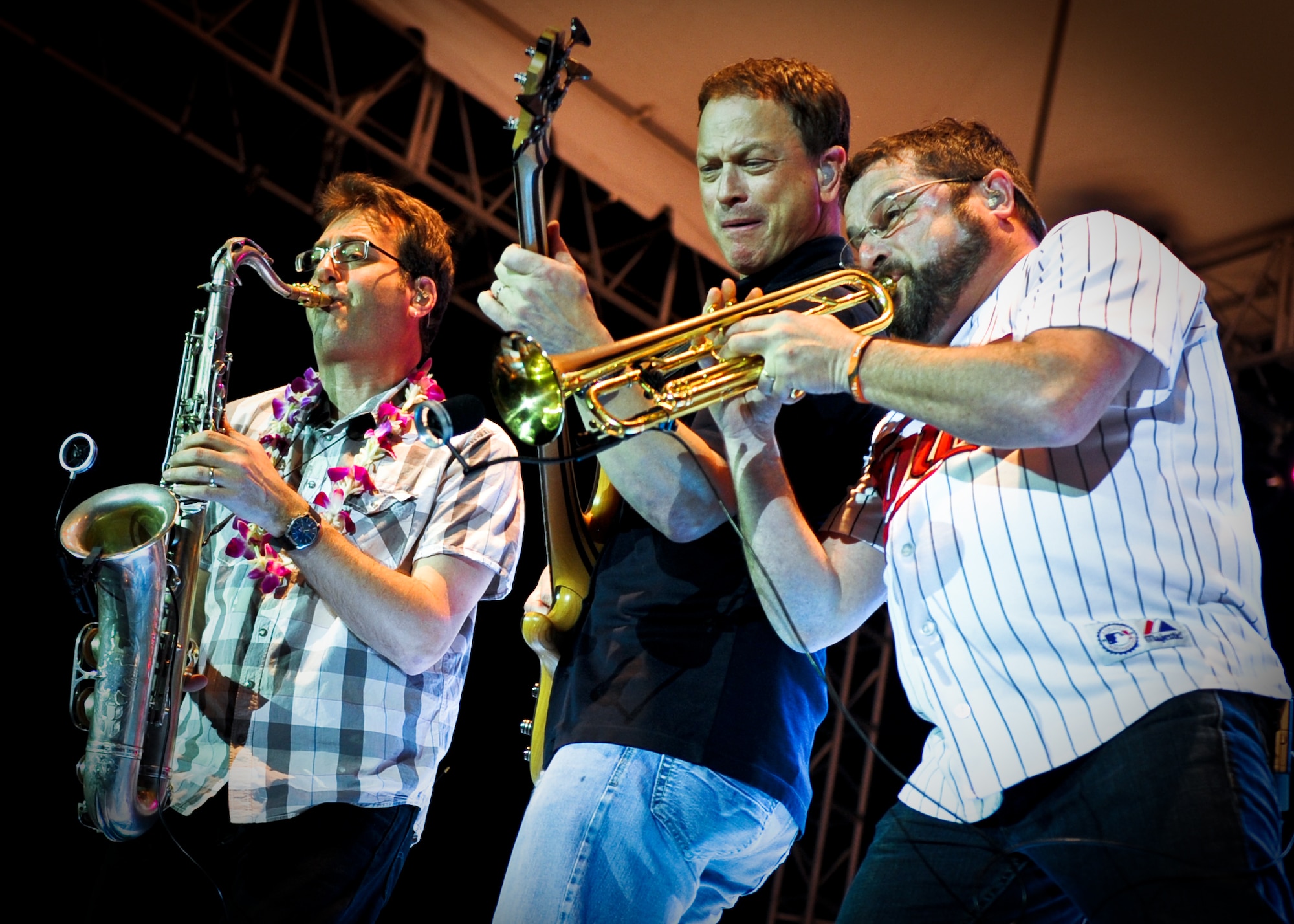 Mitch Paliga, Gary Sinese and Kirk Garriso, members of the Lt. Dan Band, perform a concert for the troops Feb. 10 at Joint Base Pearl Harbor-Hickam, Hawaii. The Lt. Dan Band derives its name from the character Sinise played in the 1994 film "Forrest Gump." (U.S. Air Force photo/Senior Airman Lauren Main)
