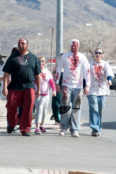 HOLLOMAN AIR FORCE BASE, N.M. – Members of the Holloman and Alamogordo communities participate in the Alamogordo Zombie Walk adorned in attire suited for victims of the walking dead in downtown Alamogordo Feb. 4. The event was in celebration of “Night of the Living Dead” director George A. Romero’s birthday, and was the first of its kind for the Holloman and Alamogordo communities. (U.S. Air Force photo by Airman 1st Class Anthony M. Ward/Released)