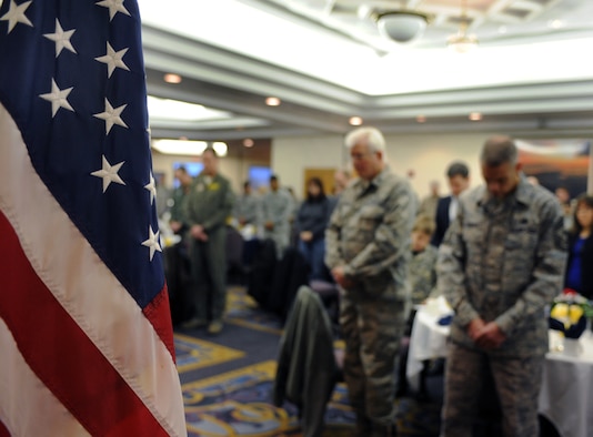 WHITEMAN AIR FORCE BASE, Mo. -- Whiteman Airmen and community members bow their heads in prayer during the annual National Prayer Breakfast Feb. 7. The breakfast is designed to be a forum for political, social, and business leaders of the world to assemble together and build relationships in the spirit of Jesus Christ which might not otherwise be possible. The tradition has taken place since 1953. (U.S. Air Force photo by Senior Airman Laura Goodgame) 