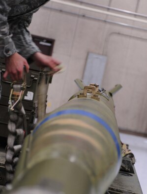 WHITEMAN AIR FORCE BASE, Mo. -- Senior Airman Siu Yu Leung quickly removes the safety straps from the inert GBU 28-C/B bomb during the annual 509th Aircraft Maintenance Squadron?s weapons load crew competition Feb. 3. The timed competition places simulated stress on the weapons Airmen providing them the opportunity to perform meticulous work quickly, building confidence in their skill set with no actual threat. Leung is a weapons Airman assigned to the 509th AMXS. (U.S. Air Force photo/Senior Airman Laura Goodgame) 