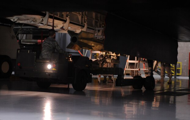 WHITEMAN AIR FORCE BASE, Mo. ? Senior Airman Siu Yu Leung loads an inert GBU 28-C/B bomb onto a B-2 Bomber during the annual load crew of the year competition Feb. 3. The competition is timed and judged on several aspects to include zero deficiencies during the weapons load evaluation. Leung is a weapons Airman assigned to the 509th Aircraft Maintenance Squadron. (U.S. Air Force photo/Senior Airman Laura Goodgame)