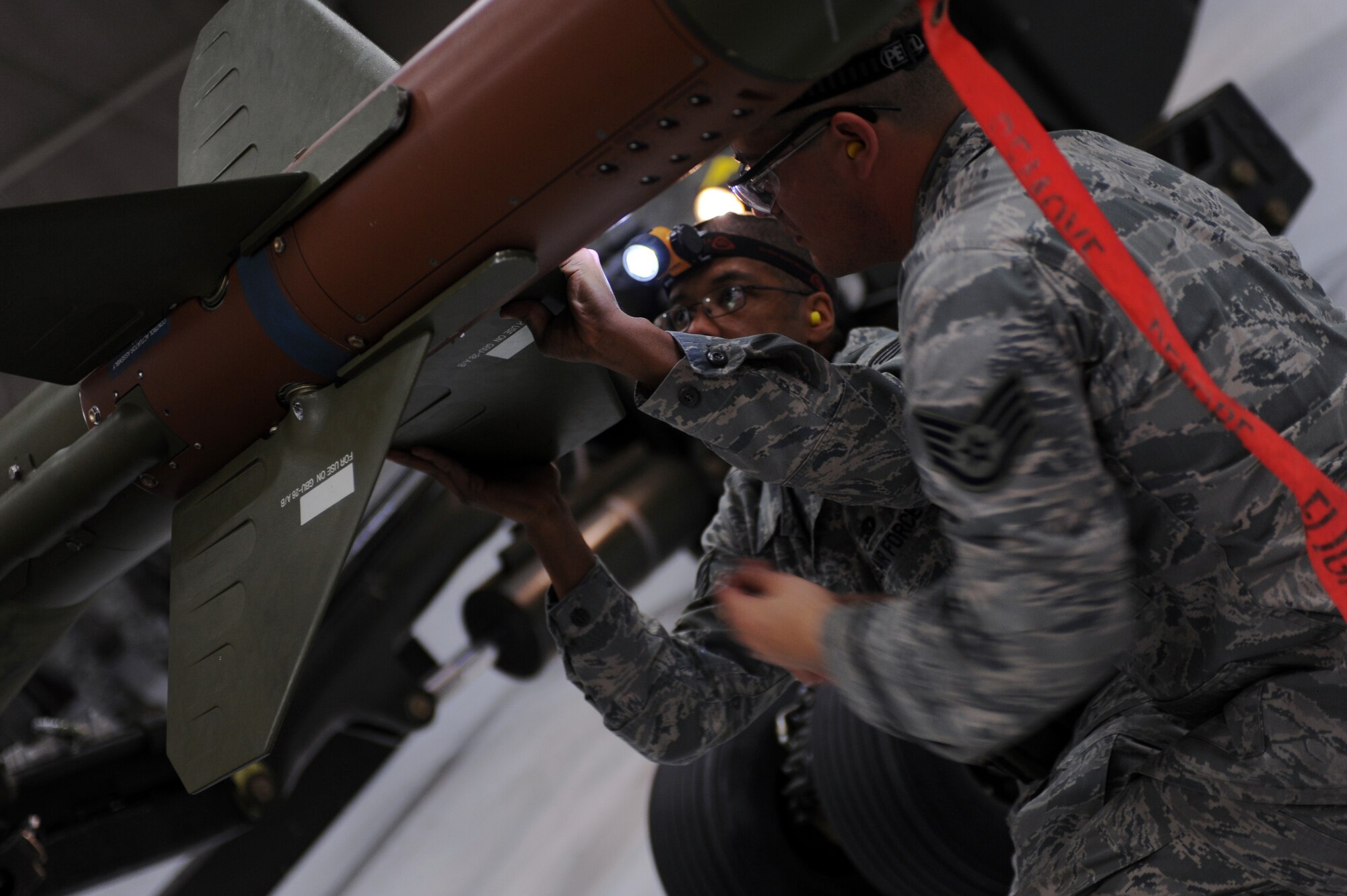 WHITEMAN AIR FORCE BASE, Mo. -- Tech. Sergeant Joshua Cameron attaches the fins on an inert GBU 28-C/B bomb during the annual load crew of the year competition Feb. 3. The competition is scored in four different areas to include dress and appearance, composite tool kit inspection, a written test, and a loading evaluation. To be eligible to compete the crews must have zero deficiencies and must win Load Crew of the Quarter. Cameron is a weapons Airman assigned to the 509th Aircraft Maintenance Squadron.  (U.S. Air Force photo/Senior Airman Laura Goodgame) 