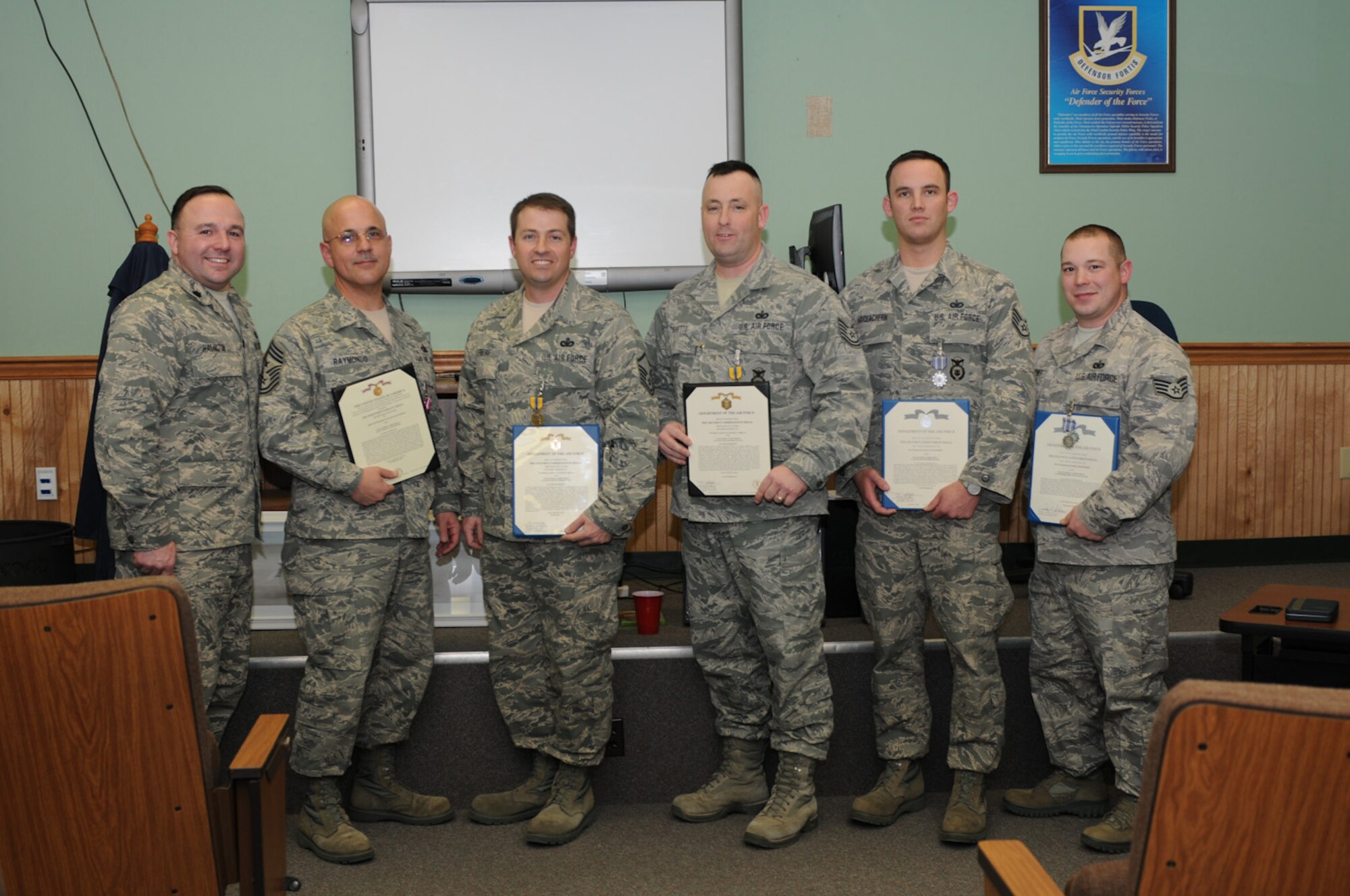 Five members of the 102nd Security Forces Squadron were awarded various medals 
during a Feb. 12 awards ceremony at Otis Air National Guard Base, Mass. The medals were awarded for outstanding achievement in direct support of Operations Iraqi Freedom and New Dawn during their deployment to Iraq in 2010. Pictured left to right are Lt. Col. Christopher Hamilton, Command Chief Master Sgt. Wayne Raymondo, Master Sgt. Steven Frietas, Tech. Sgt. Stephen Tibbetts, Staff Sgt. Colin MacEachern and Staff Sgt. James Hightower. (National Guard photo by Tech. Sgt. Kerri Cole/Released)