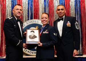 Col. Richard McComb and Chief Master Sgt. Jose LugoSantiago present the John L. Levitow Award to Senior Airman Amy Lexon during the Airman Leadership School Class graduation at Joint Base Charleston - Air Base Feb. 9. The award is presented to the student who displays exemplary excellence as both a leader and a scholar. McComb is the JB Charleston commander and LugoSantiago is the 628th Air Base Wing command chief. Lexon is a Phoenix Raven journeyman assigned to the 628th Security Forces Squadron. (U.S. Air Force photo/Staff Sgt. Katie Gieratz) 

