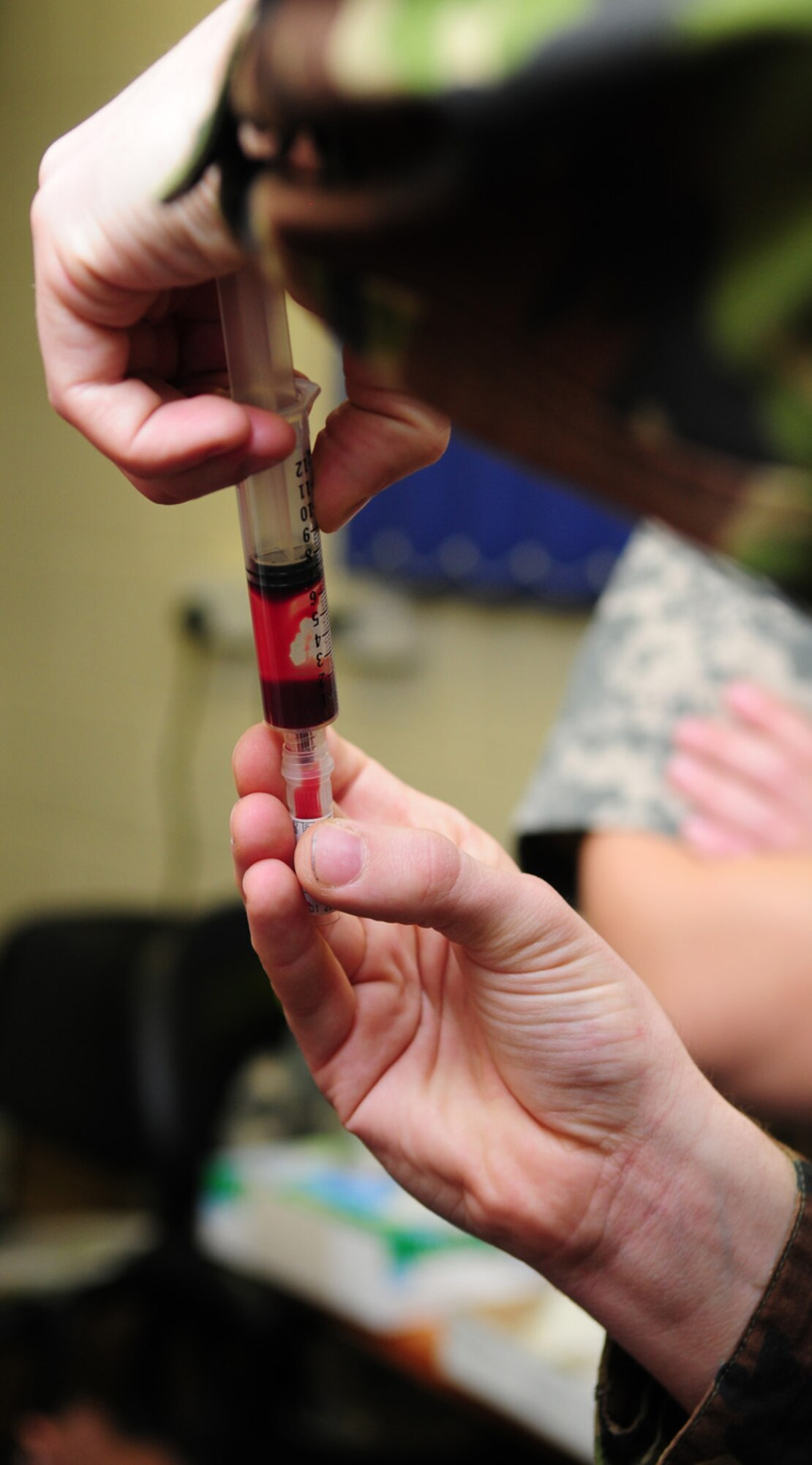 RAF MILDENHALL, England – Lance Cpl. Simon Williams, Royal Army Veterinary Corps technician, Defence Animal Centre, Melton Mowbray, fills a blood tube after drawing the blood from one of the 100th Security Forces Squadron Military Working Dogs here during a semi-annual check Jan. 31, 2012. The samples will be sent to a laboratory for routine testing. Williams and another Royal Army Vet Corps technician were here working with the RAF Feltwell Vet Clinic as part of an exchange program to build partnerships between the two nations’ militaries. (U.S. Air Force photo/Karen Abeyasekere)