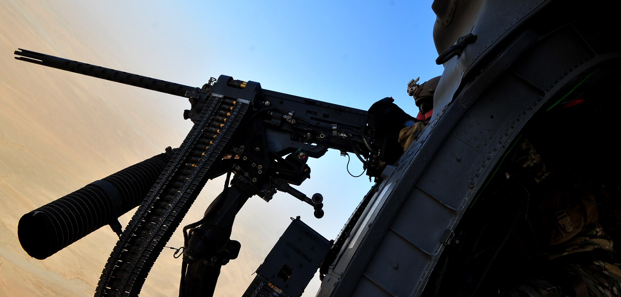 CAMP BASTION, Afghanistan -- An aircrew member from the 26th Expeditionary Rescue Squadron mans the 50 caliber machine gun mounted to a HH-60G Pave Hawk helicopter. The 26th ERQS compliments their traditional personnel recovery mission with medical evacuation operations in Afghanistan’s Regional Command Southwest. (U.S. Air Force photo by Senior Airman Tyler Placie)