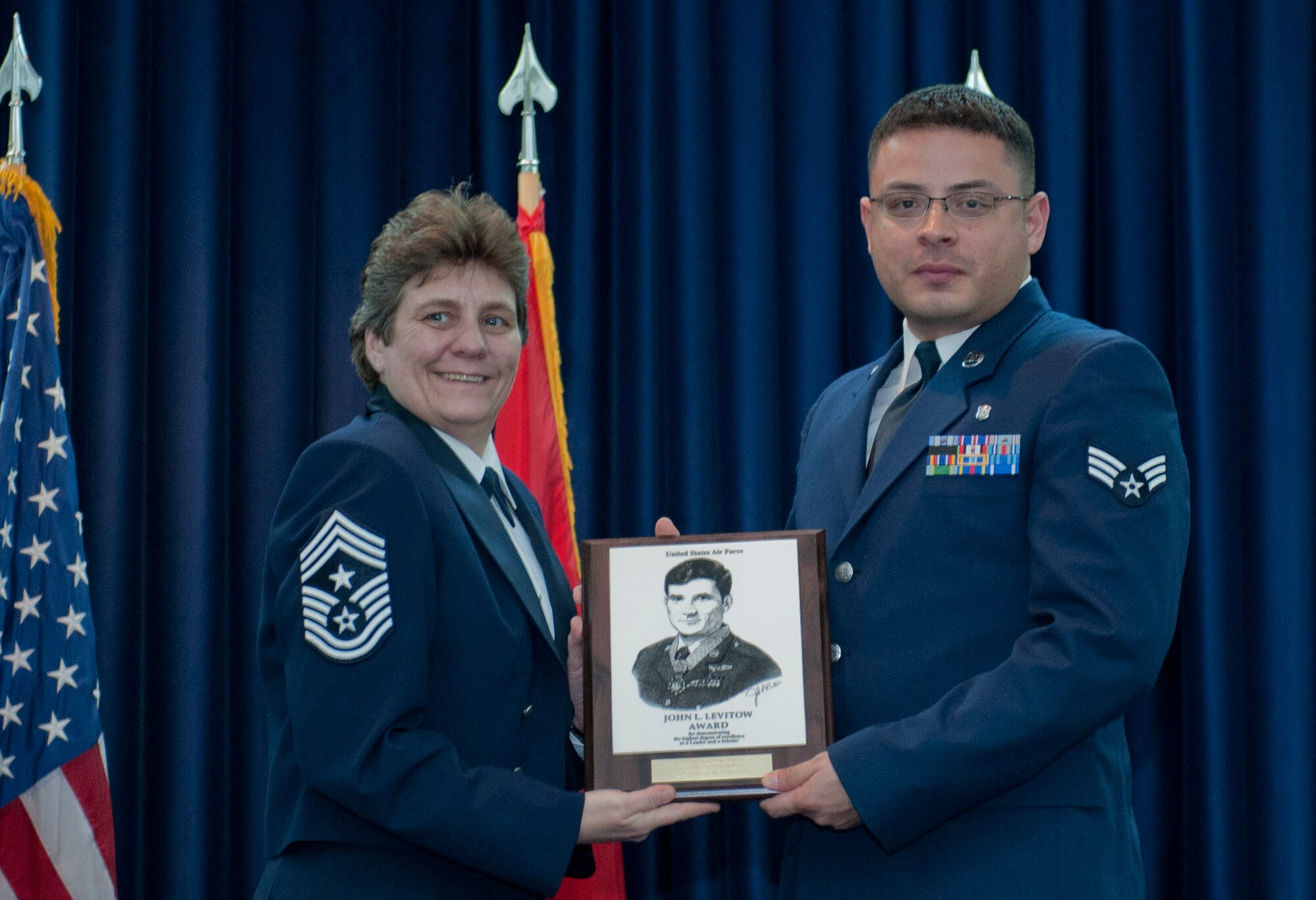Senior Airman Robert Gonzales Jr., 39th Medical Support Squadron, receives the John L. Levitow Award from Chief Master Sgt. Nancy Judge, 39th Air Base Wing command chief, during the Class 12-3 Incirlik Airman Leadership School graduation Feb. 10, 2012, at Incirlik Air Base, Turkey. The Levitow Award is the highest achievement for enlisted Airmen enrolled in U.S. Air Force professional military education. There are four levels of PME: ALS, NCO academy, Air Force Senior NCO Academy and the Chief Master Sergeant Leadership Course. (U.S. Air Force photo by Senior Airman Anthony Sanchelli/Released)