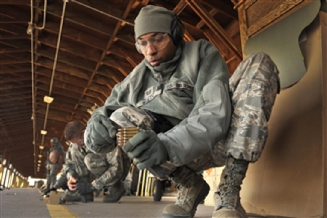Tech. Sgt. Robert Bailey loads a magazine to prepare for a firing drill at the firing range at the U.S. Air Force Academy in Colorado Springs, Colo., on Jan. 30, 2012.  All team members are required to maintain their weapons proficiency.  Bailey is assigned the 4th Space Operations Squadron Mobility Operations team.  