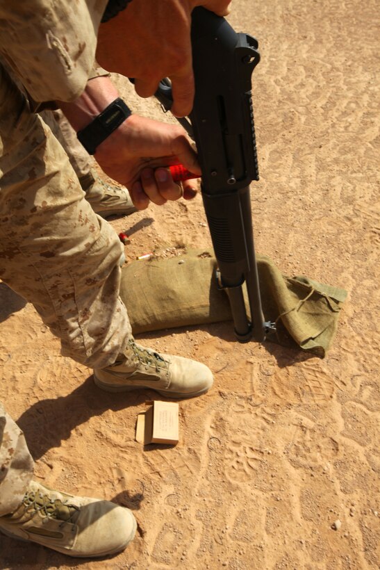 Lance Cpl. Brandon Walker, a tow gunner with 1st Platoon, Weapons Company, 1st Battalion, 23rd Marine Regiment, Task Force Belleau Wood, loads a shell into the chamber of an M1014 combat shotgun during range training on Camp Leatherneck, June 4.  The training was conducted to qualify Marines on the shotgun.  It included Marines from various posts and billets from both Charlie and Weapons Companies, 1/23.  (U.S. Marine Corps photo by Lance Cpl. Katherine M. Solano)