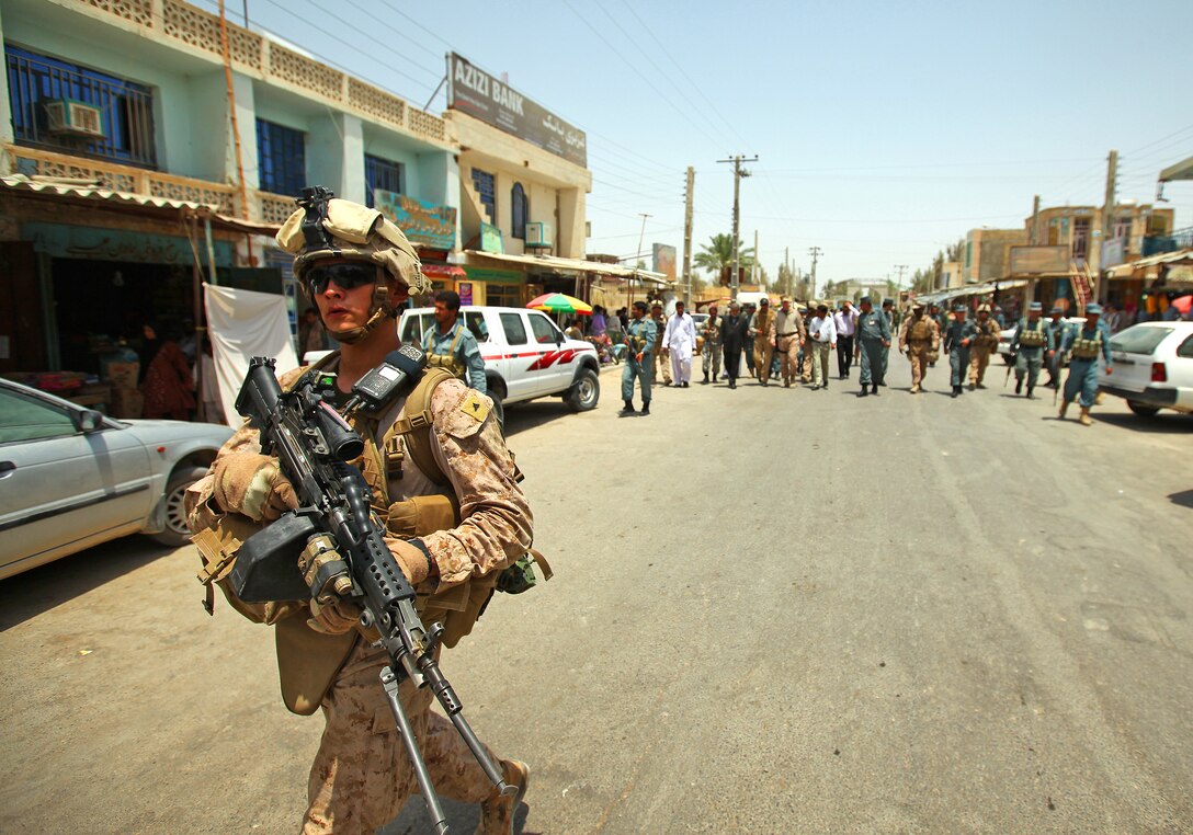 Lance Cpl. Orlando Tovar, a squad automatic rifleman with Company Charlie, 1st Battalion, 23rd Marine Regiment, Task Force Belleau Wood, patrols the streets of Zaranj during a visit from Maj. Gen. John A. Toolan, commanding general of Regional Command Southwest, June 4. Toolan met with the Nimroz provincial governor, Abdul Karim Brahawi, to participate in the opening ceremony of the city’s new hospital emergency room.