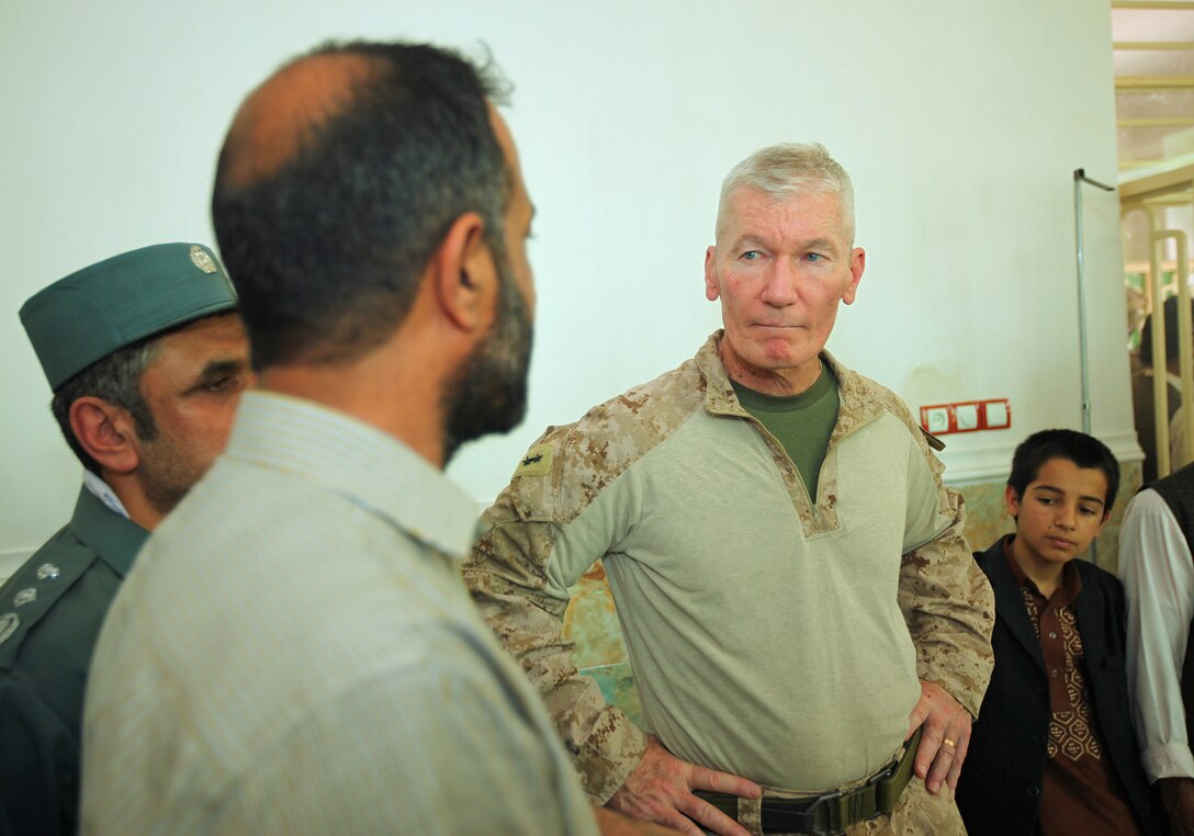 Maj. Gen. John A. Toolan, commanding general of Regional Command Southwest, speaks with members of the Nimroz Health Department inside of Zaranj's new hospital emergency room, June 4. Toolan met with the Nimroz provincial governor, Abdul Karim Brahawi, to participate in the opening ceremony of the city’s new hospital emergency room.