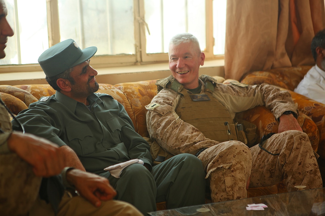 Maj. Gen. John A. Toolan (right), commanding general of Regional Command Southwest, shares a lighthearted moment with Maj. Gen. Nabi J. Mullakhel, the Deputy Chief of Police for RC(SW), before departing the city of Zaranj, June 4. Toolan met with the provincial governor of Nimroz, Abdul Karim Brahawi, to participate in the opening ceremony of the city’s new hospital emergency room.