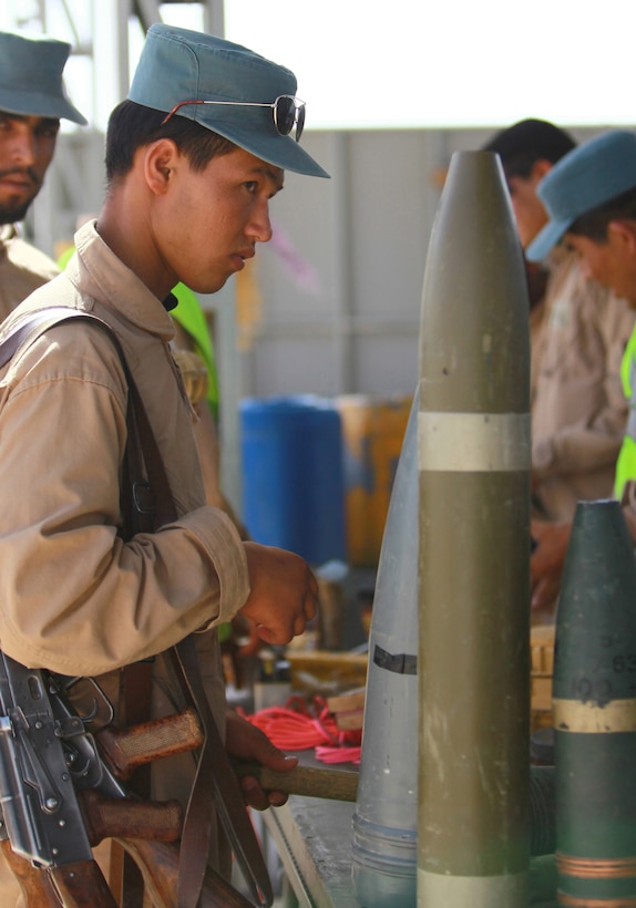 An Afghan student searches through different types of explosives during an counter- improvised explosive device class as a part of the Afghan Uniformed Police Basic Course 11-8 aboard Camp Bastion, June 6. IED's are the number one killer of Afghan and coalition forces.